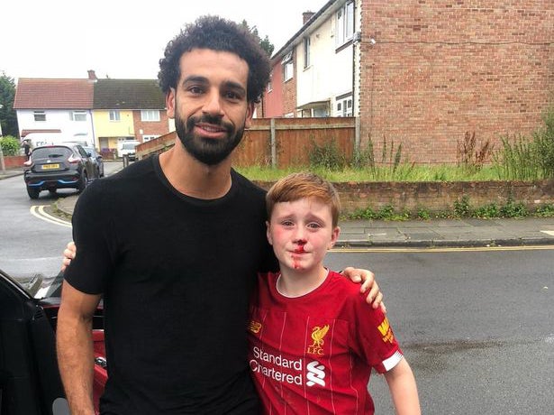 Mohamed Salah poses with young Liverpool fan