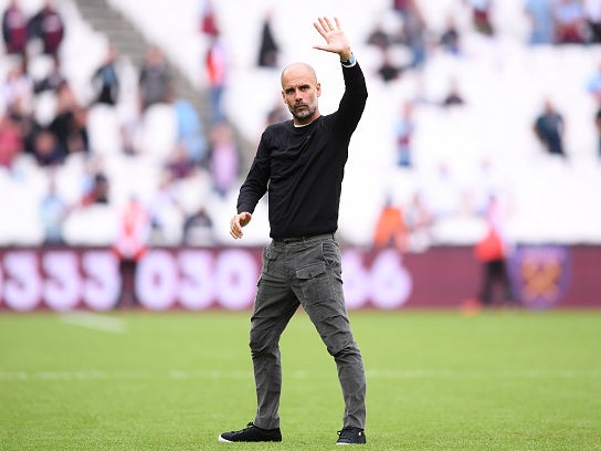 Pep Guardiola waves to Manchester City’s fans after the full-time whistle