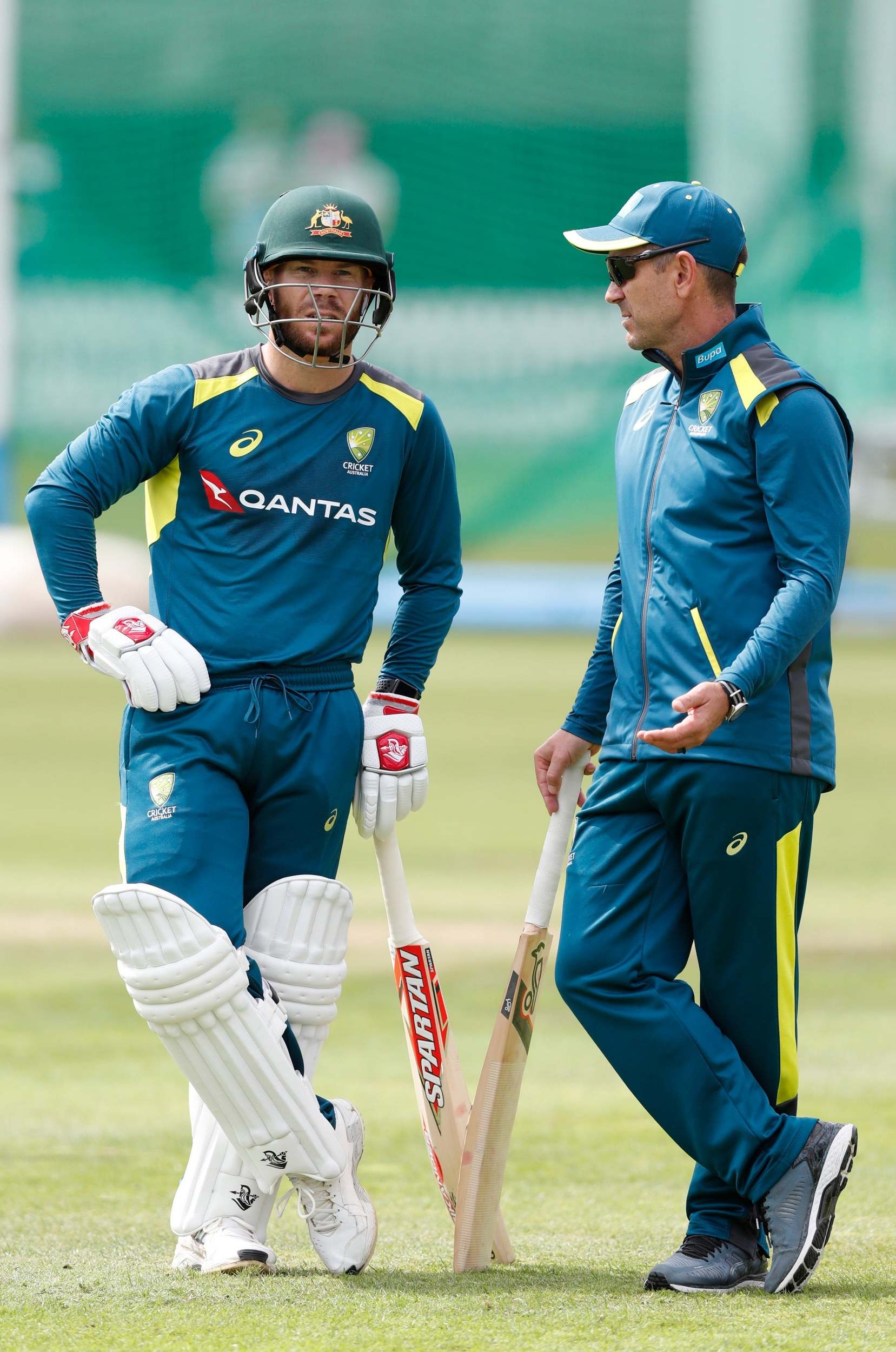 Justin Langer and David Warner chat during a net session