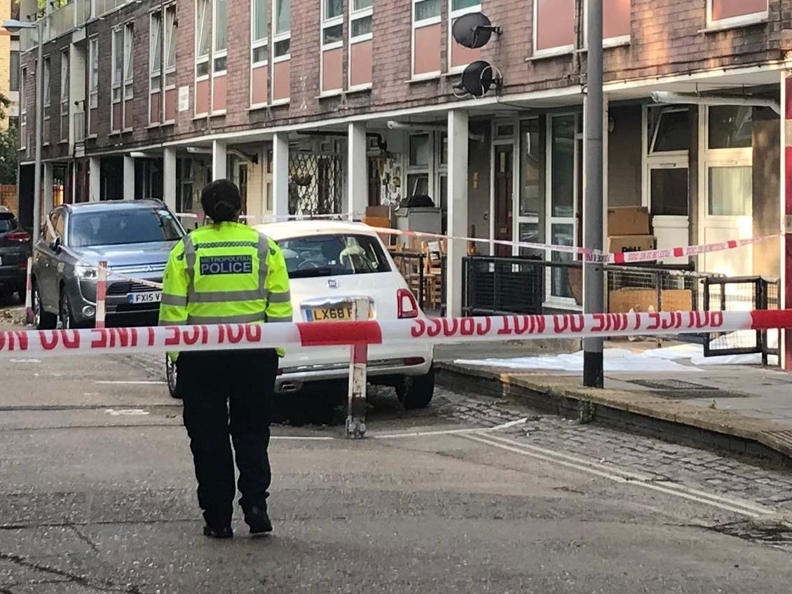 A police officer stands near the scene of a fatal stabbing on 12 August in Munster Square, Camden