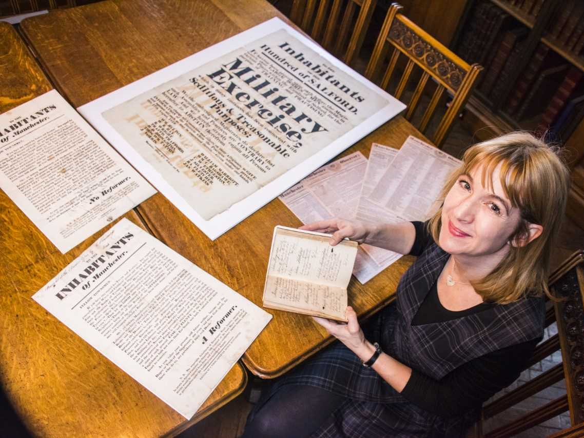 Janette Martin with items from the John Rylands Library Peterloo exhibition
