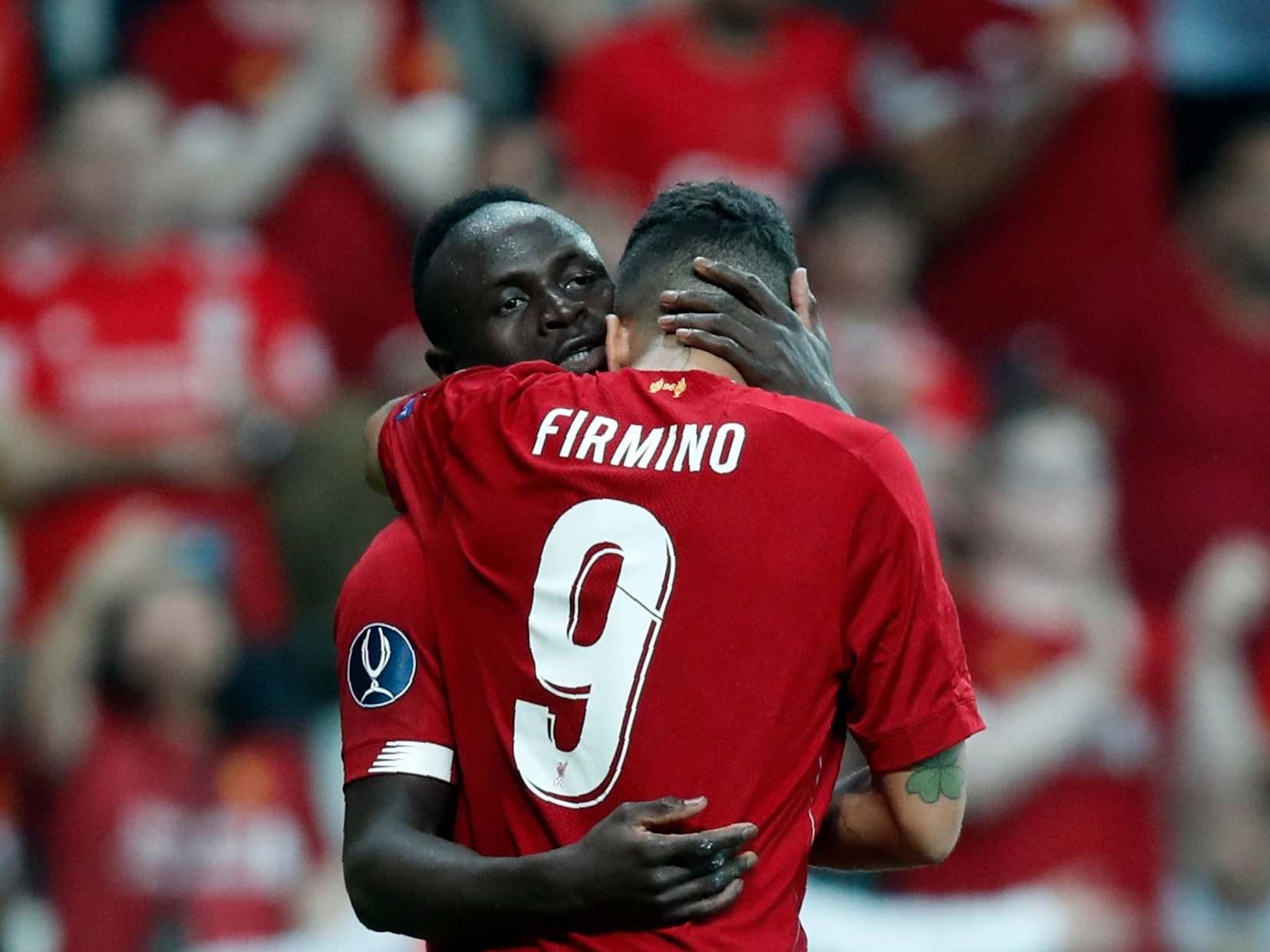 Sadio Mane and Roberto Firmino embrace after equalising vs Chelsea