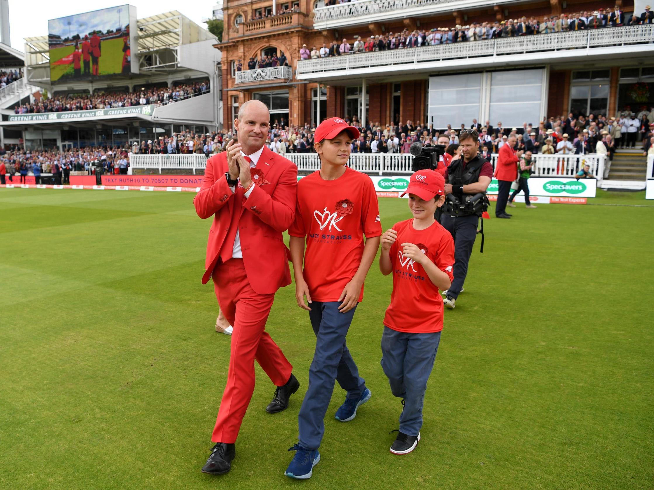 Andrew Strauss and his two sons lead out the teams at Lord's