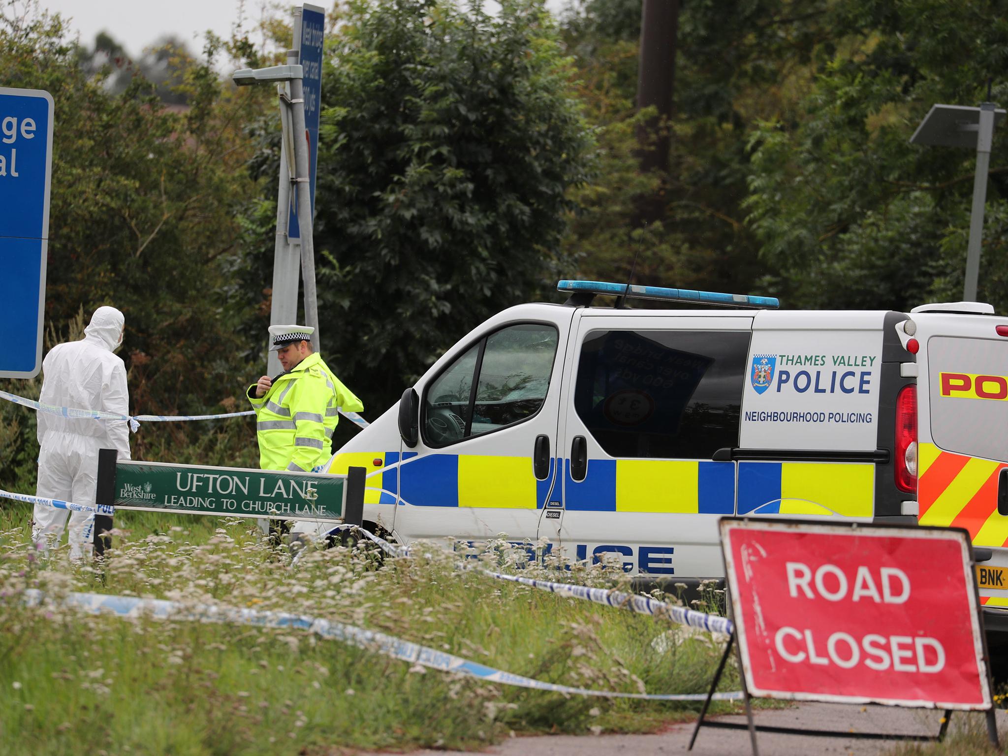 Police officers at the scene on Ufton Lane, near Sulhamstead, Berkshire, on Friday