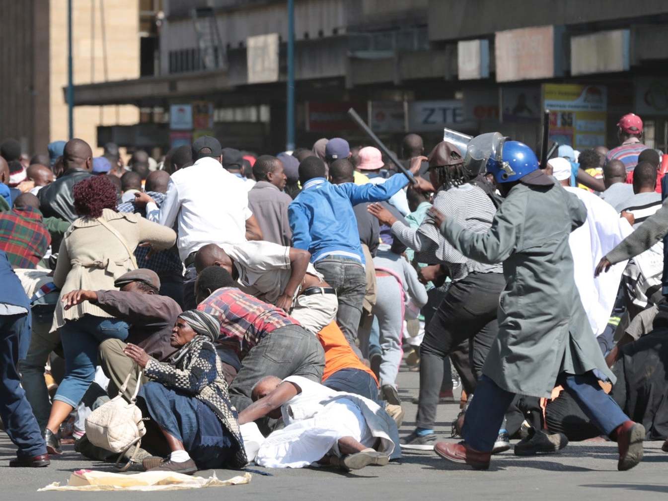 Zimbabwe Republic Police (ZRP) officers clash with members of the public who took part in the Democratic Change (MDC) Alliance organised Peace March in Harare, Zimbabwe