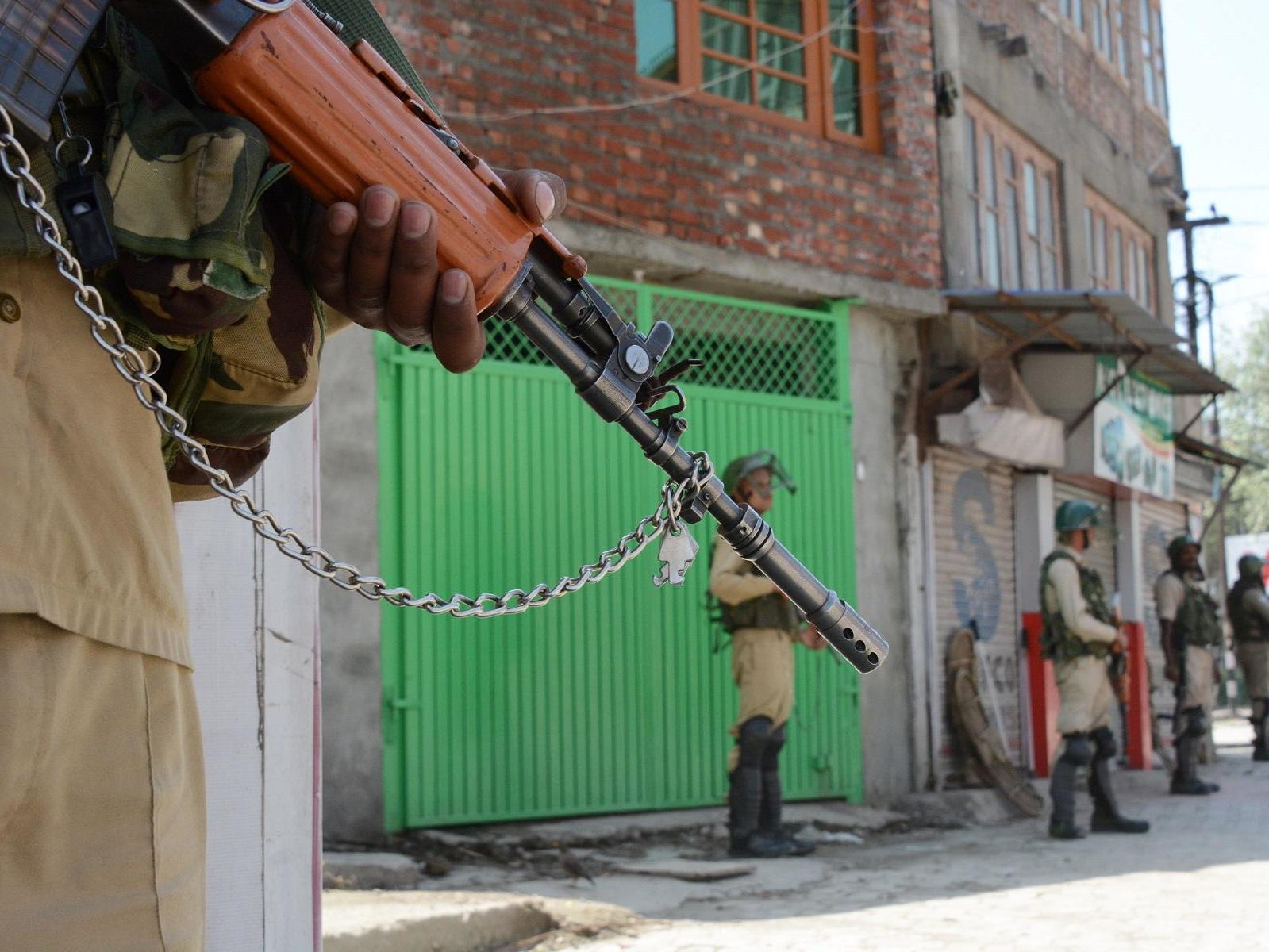 Security personnel stand guard in central Srinagar on the 15th day of lockdown in Kashmir