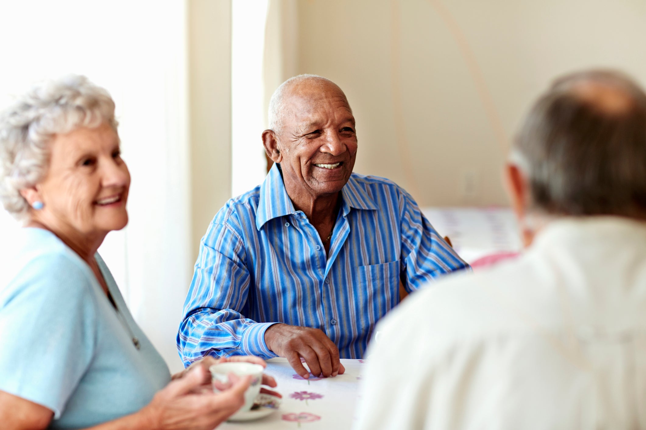 Senior man having coffee with friends