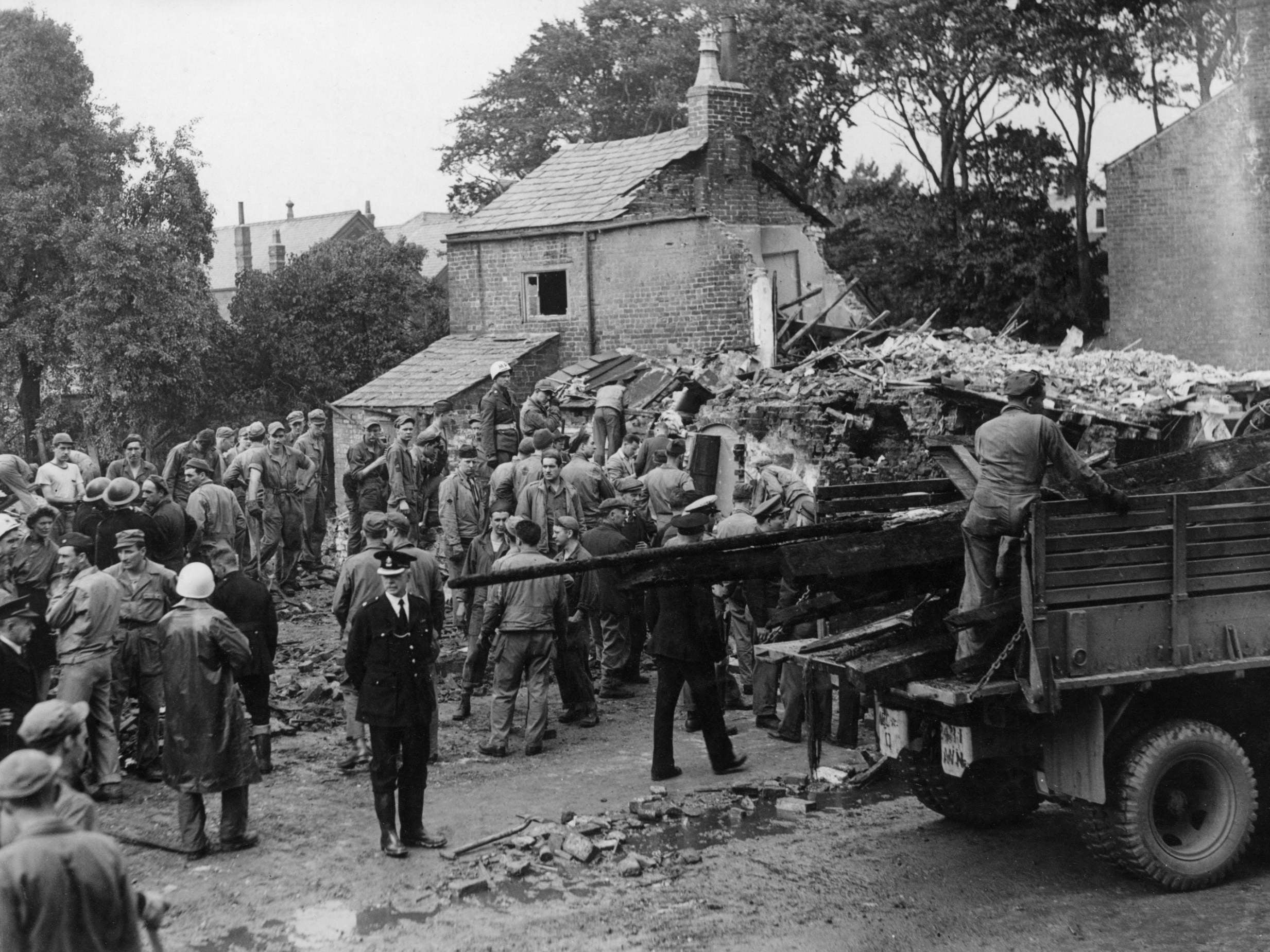 American airmen and villagers desperately search for survivors after the accident