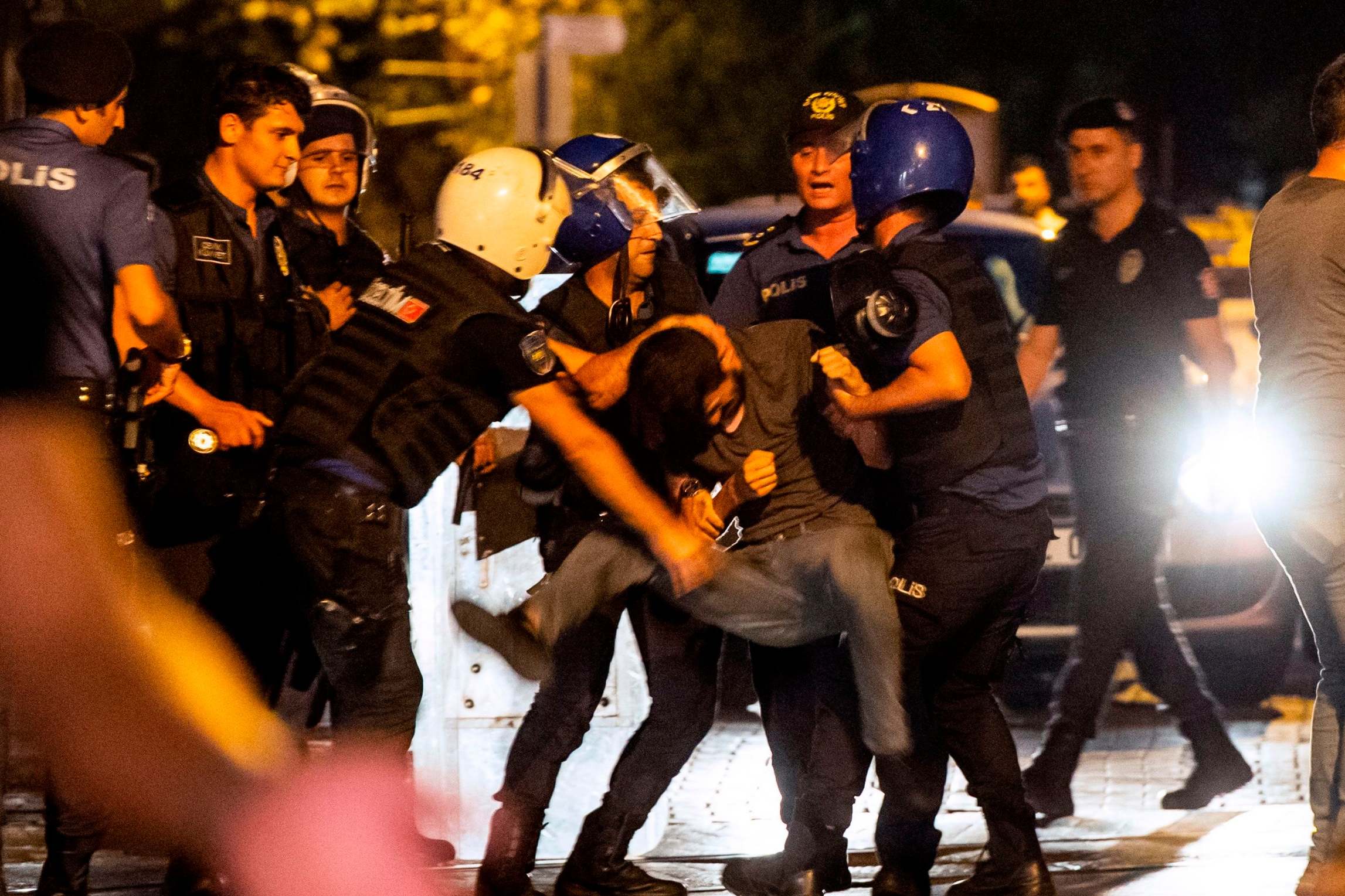 A protester is detained by police during a demonstration against the replacement of Kurdish mayors with state officials in three cities (AFP/Getty)