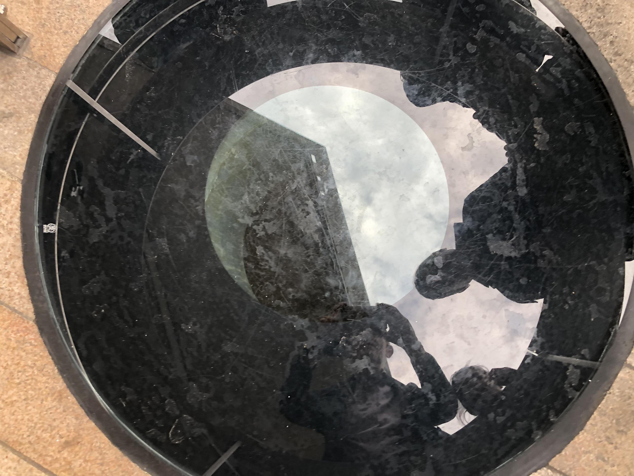 Peer group: shoppers in Liverpool looking down into the Old Dock