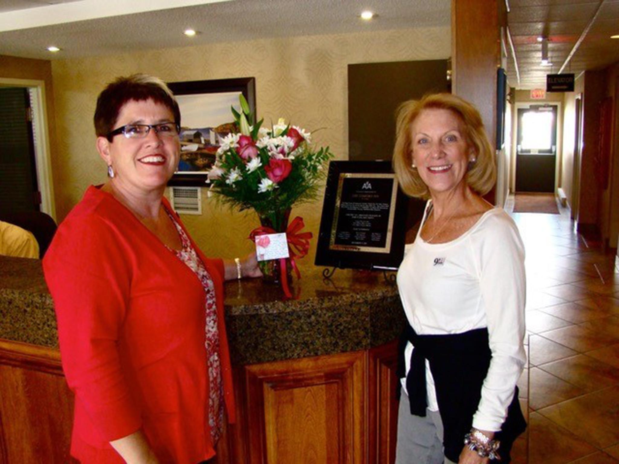 Bass with Karen Mills, manager of the Comfort Inn. Bass sends flowers every year (Beverley Bass/American Airlines)