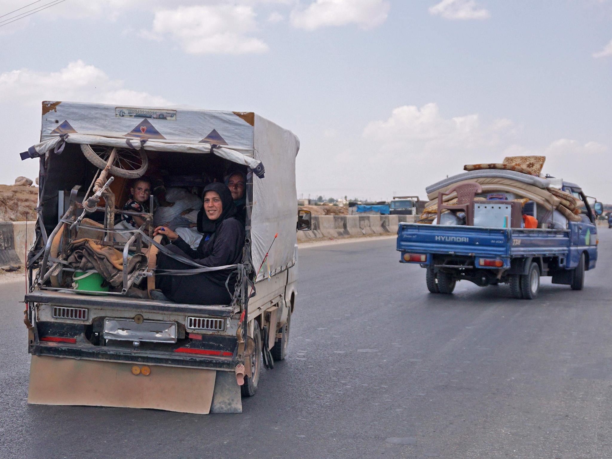 Syrians fleeing from the town of Maaret al-Numan and its surrounding countryside in the northwestern Idlib province in August