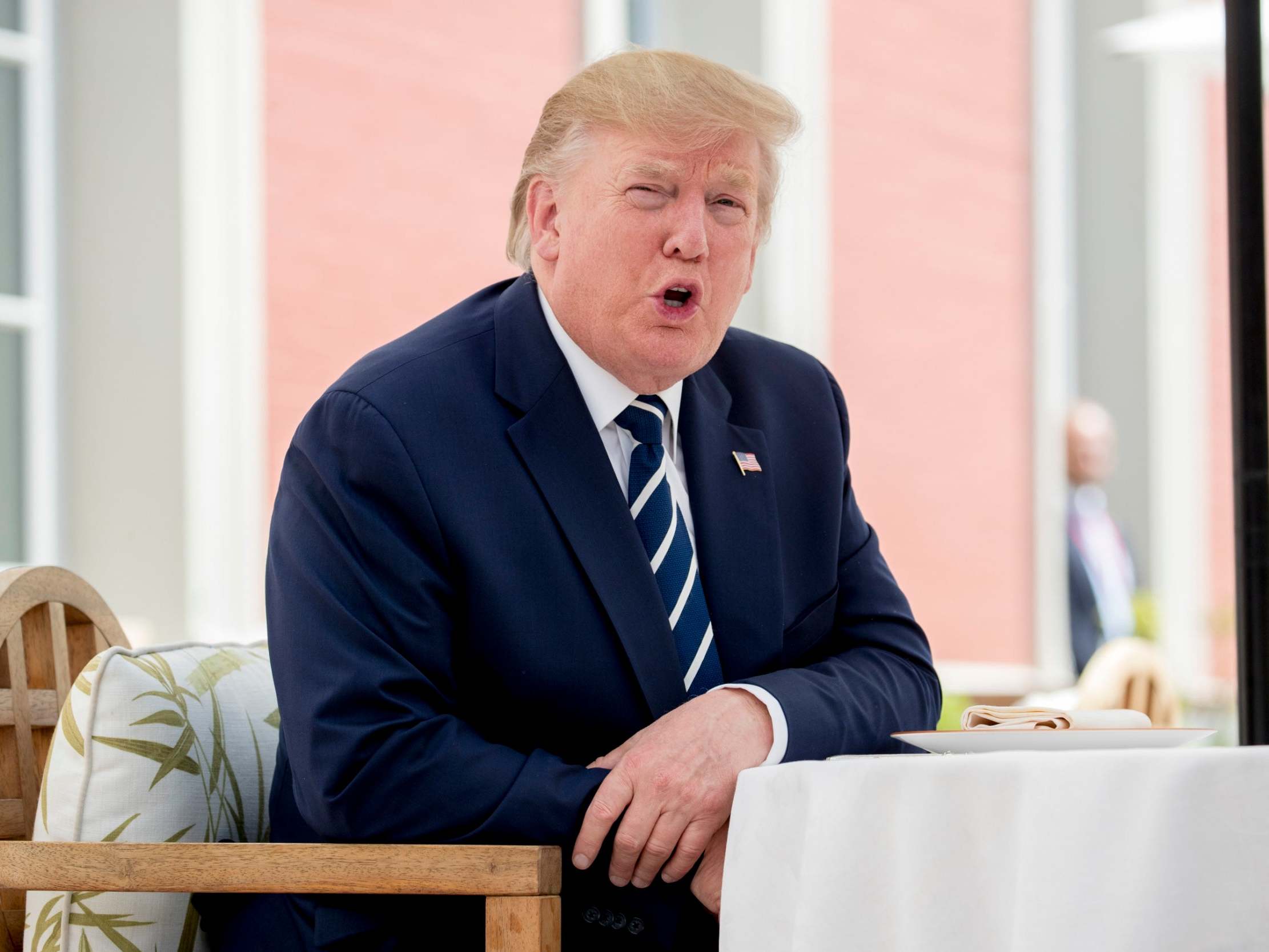 Donald Trump talks to the media as he sits for lunch with French president Emmanuel Macron.