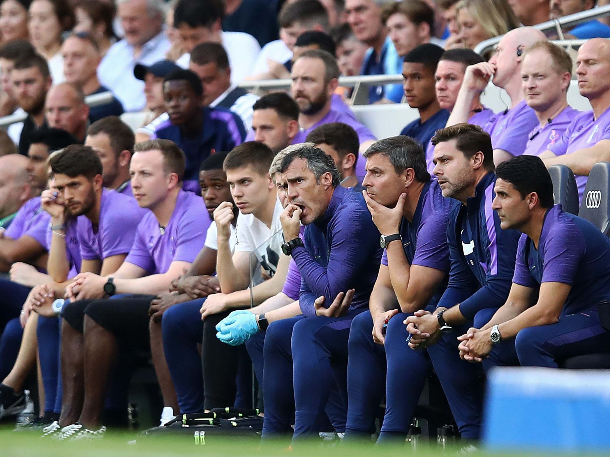 Pochettino and the Tottenham bench look on