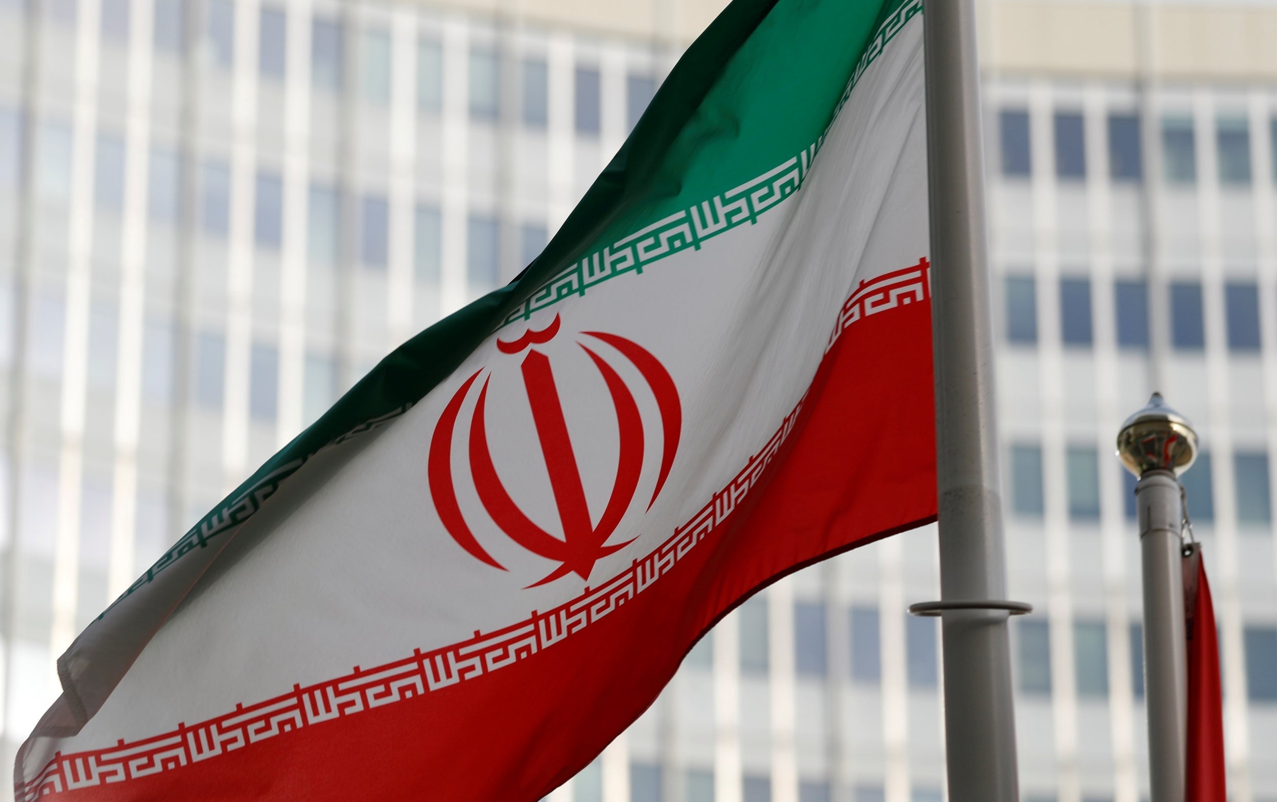 The Iranian flag flutters in front the International Atomic Energy Agency