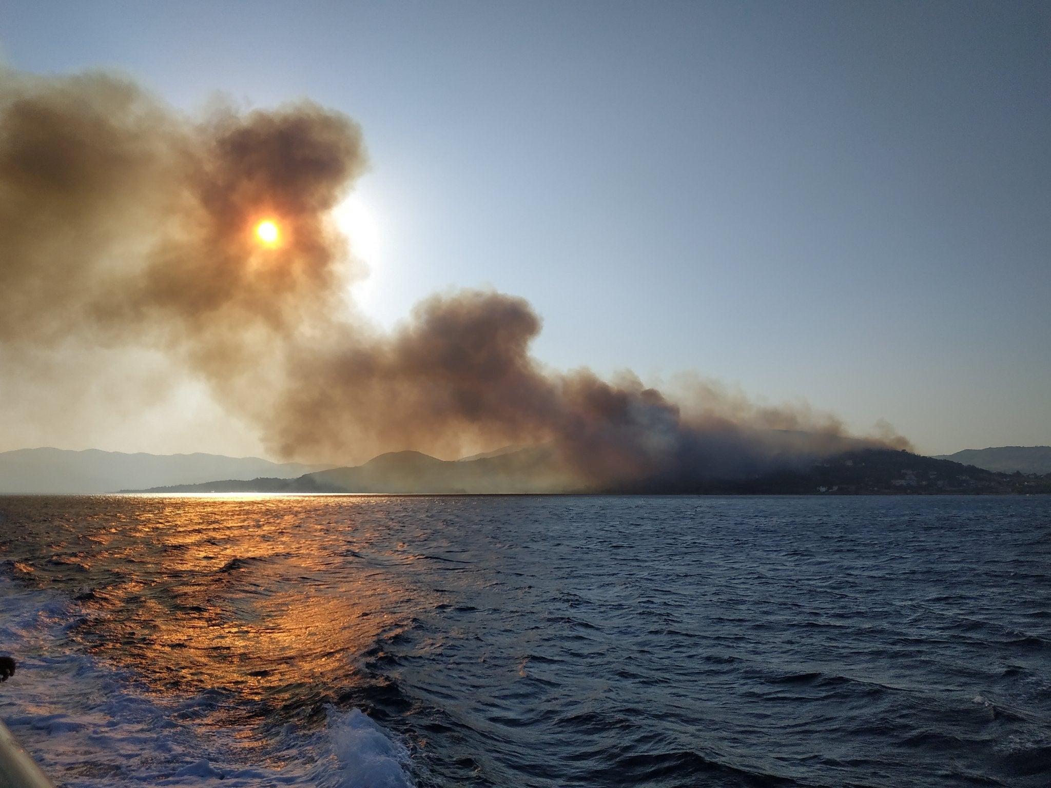 Smoke billows over the sea during a fire on Samos island