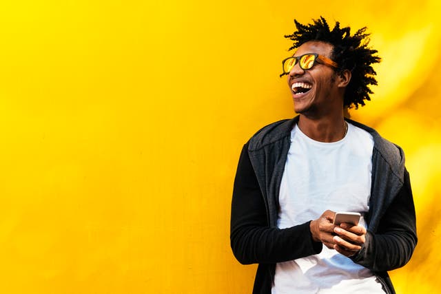 Portrait of happy man using phone