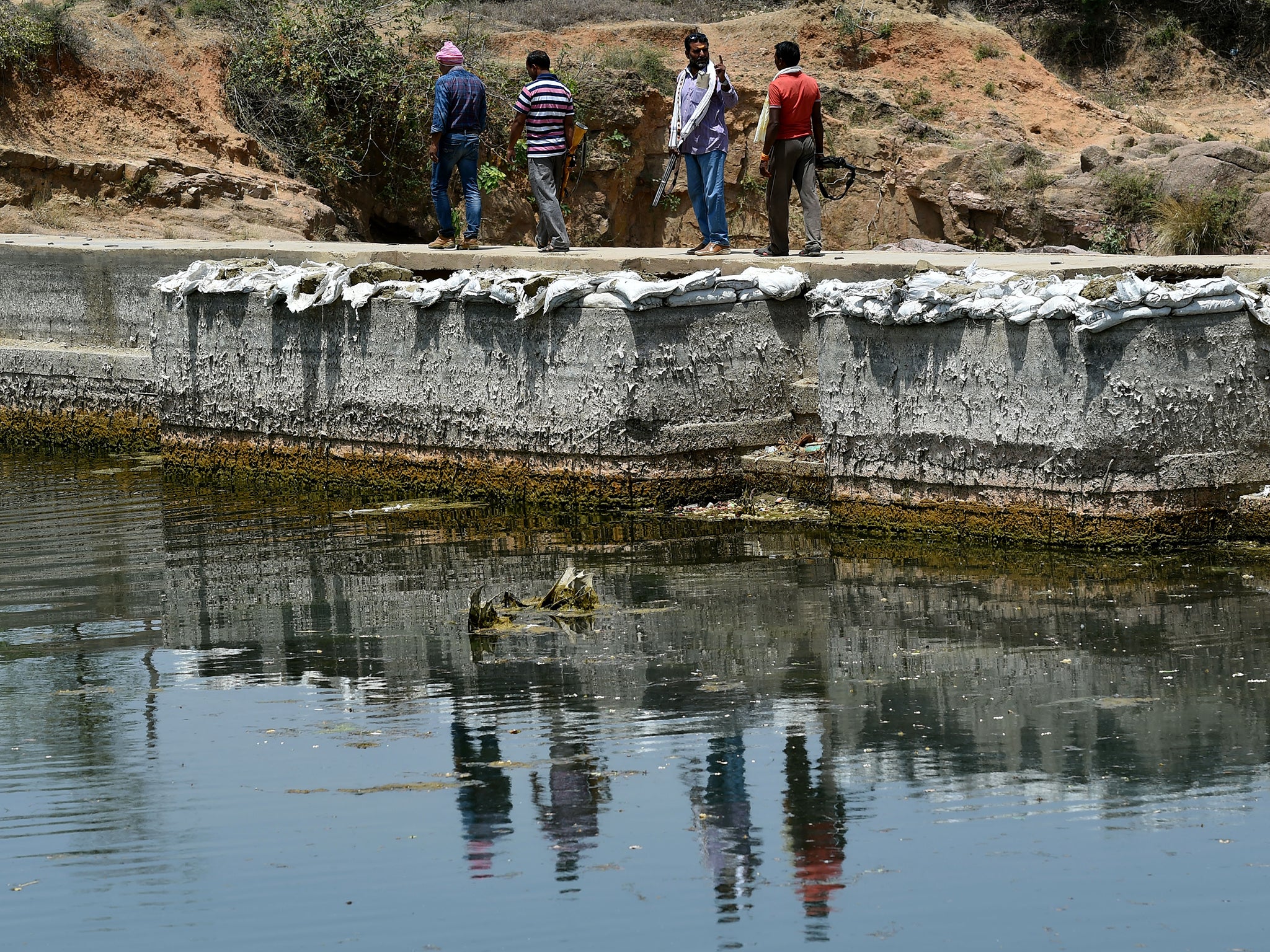 Gunmen protect a water reservoir from thefts in the parched Bundelkhand region