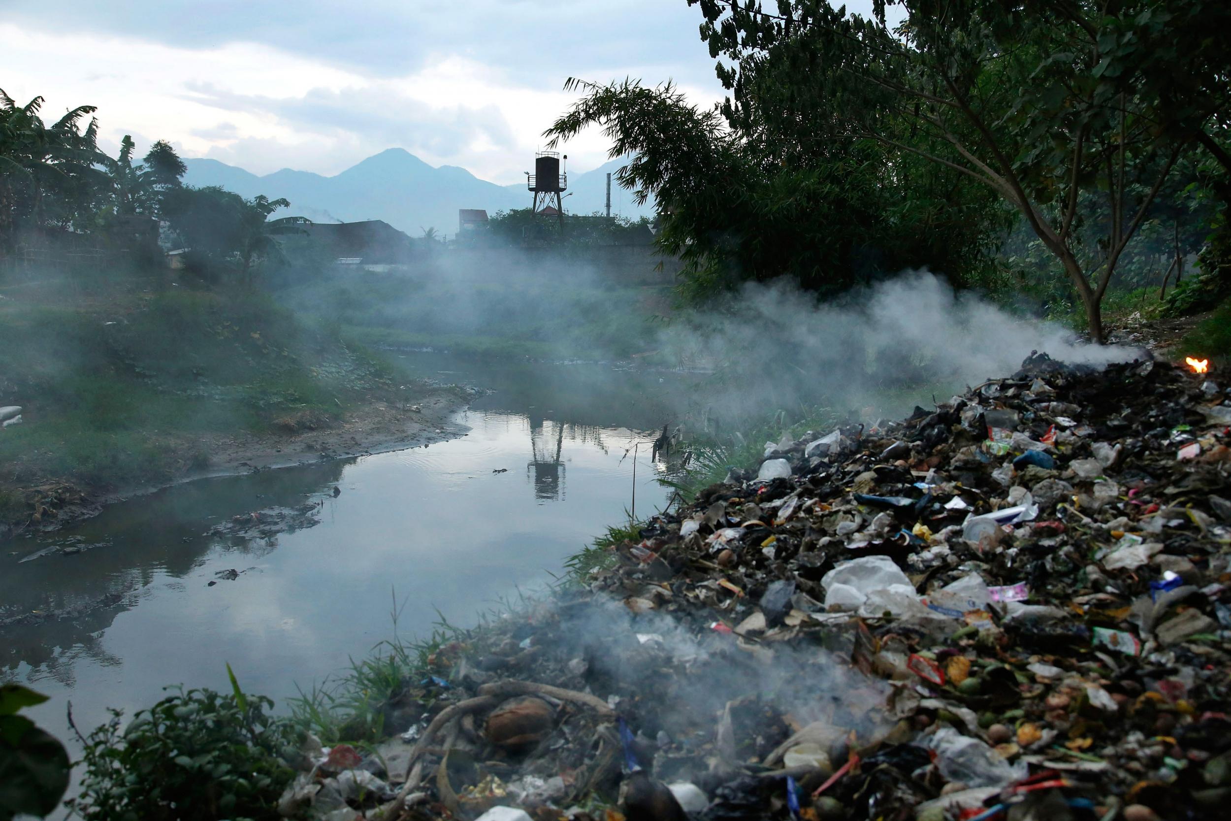 Burning waste beside the Citarum river, near the town of a major textile producer in Majalaya, Indonesia (Getty)