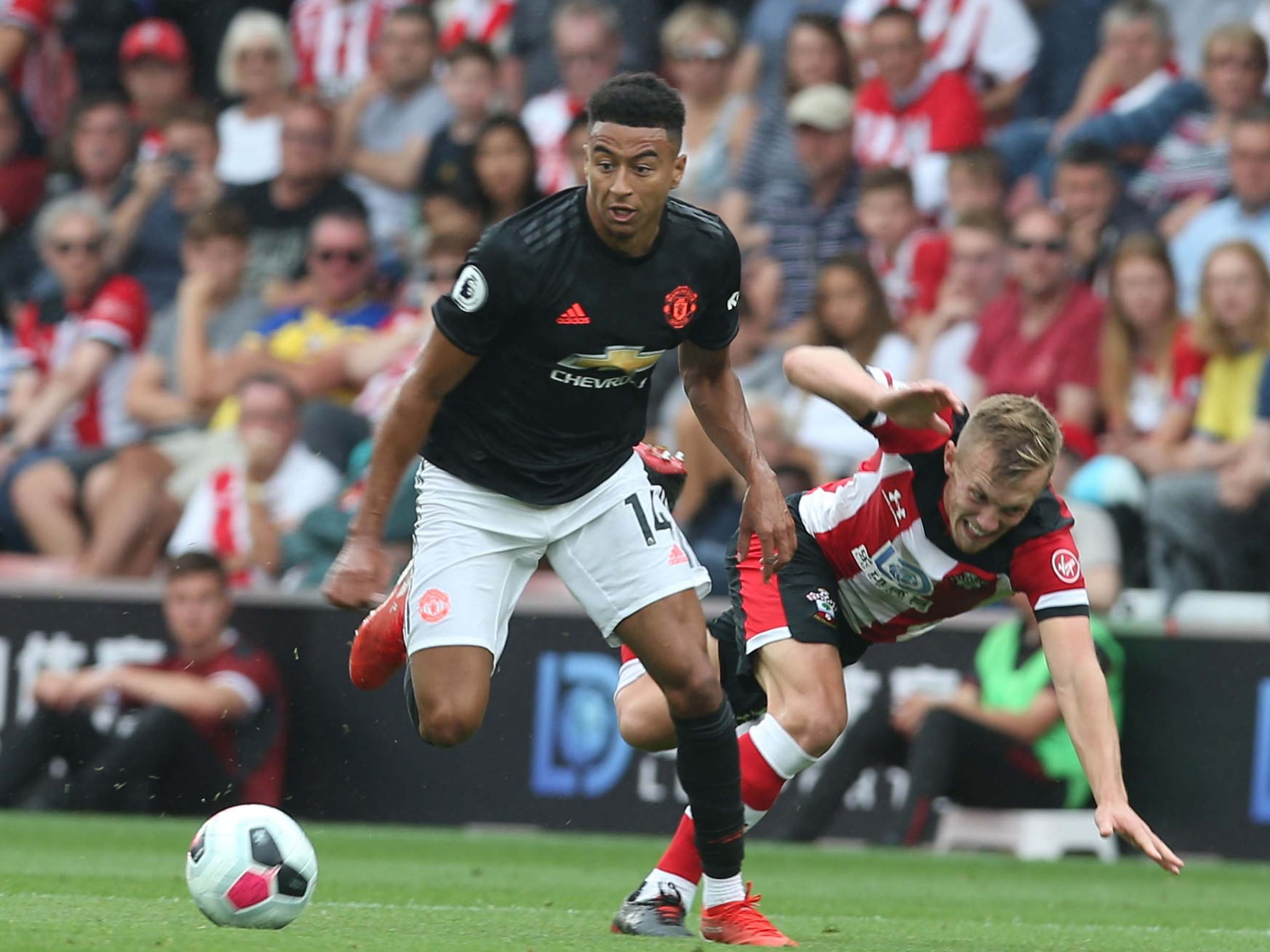 Jesse Lingard dribbles past James Ward-Prowse