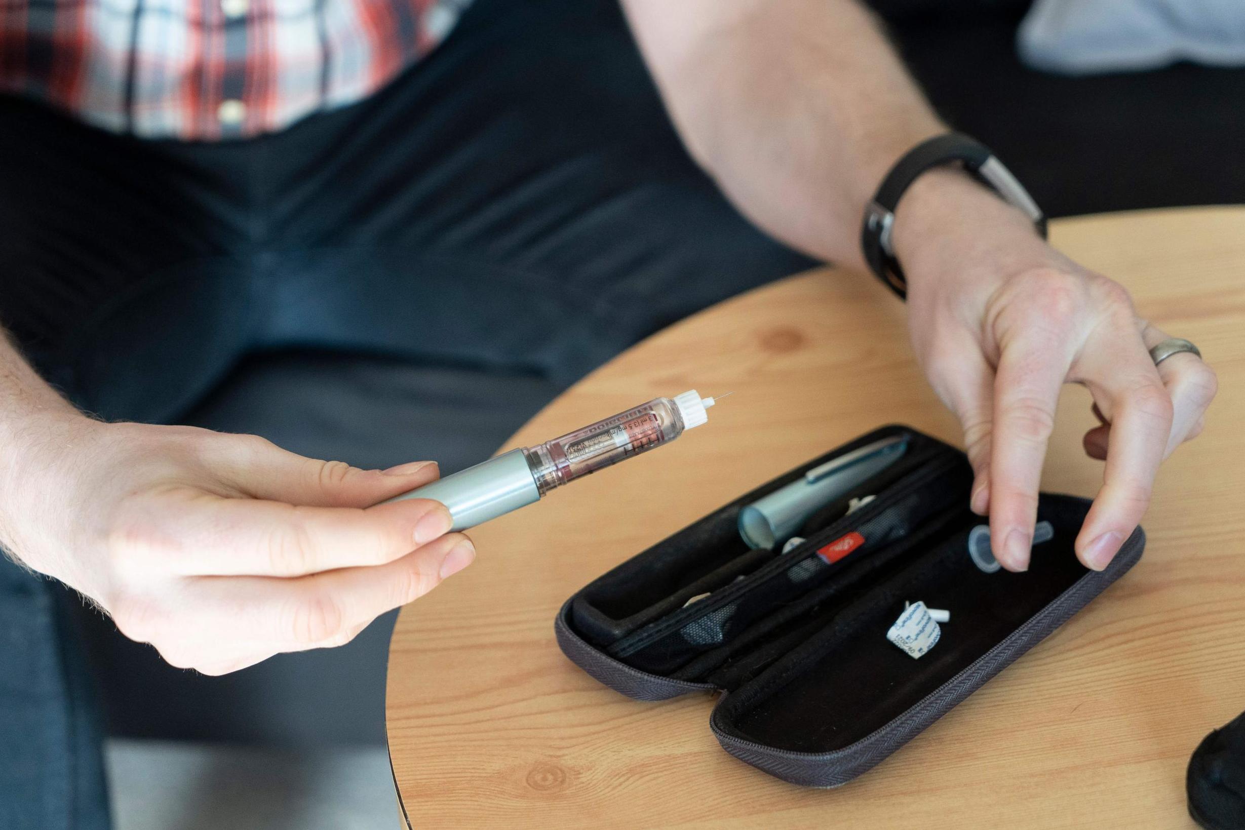 A diabetes patient prepares to inject himself with insulin in London