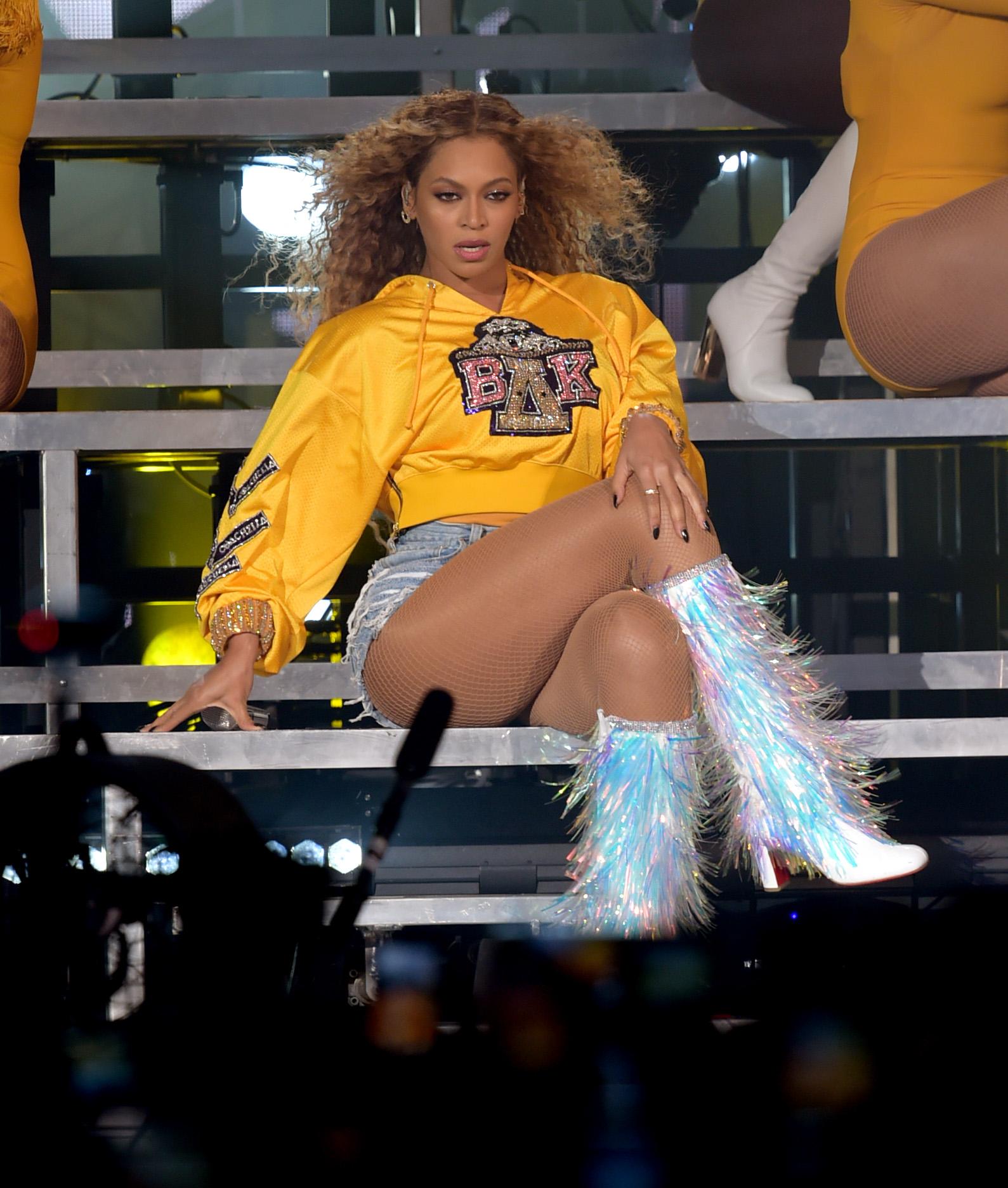 In April 2018, Beyoncé made history when she headlined the Coachella Valley Music and Arts Festival in Indio, California. The singer wore a series of outfits during the performance, one of the most memorable of which was a yellow sweatshirt with high-waisted denim shorts and frayed silver knee-high boots. During her second headlining performance, Beyoncé wore the same outfit in pink, instead of yellow.