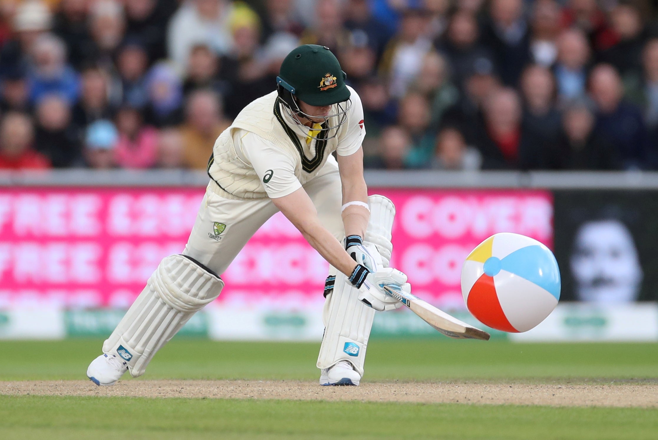 Steve Smith sweeps a beach ball that had blown into the middle (Reuters)