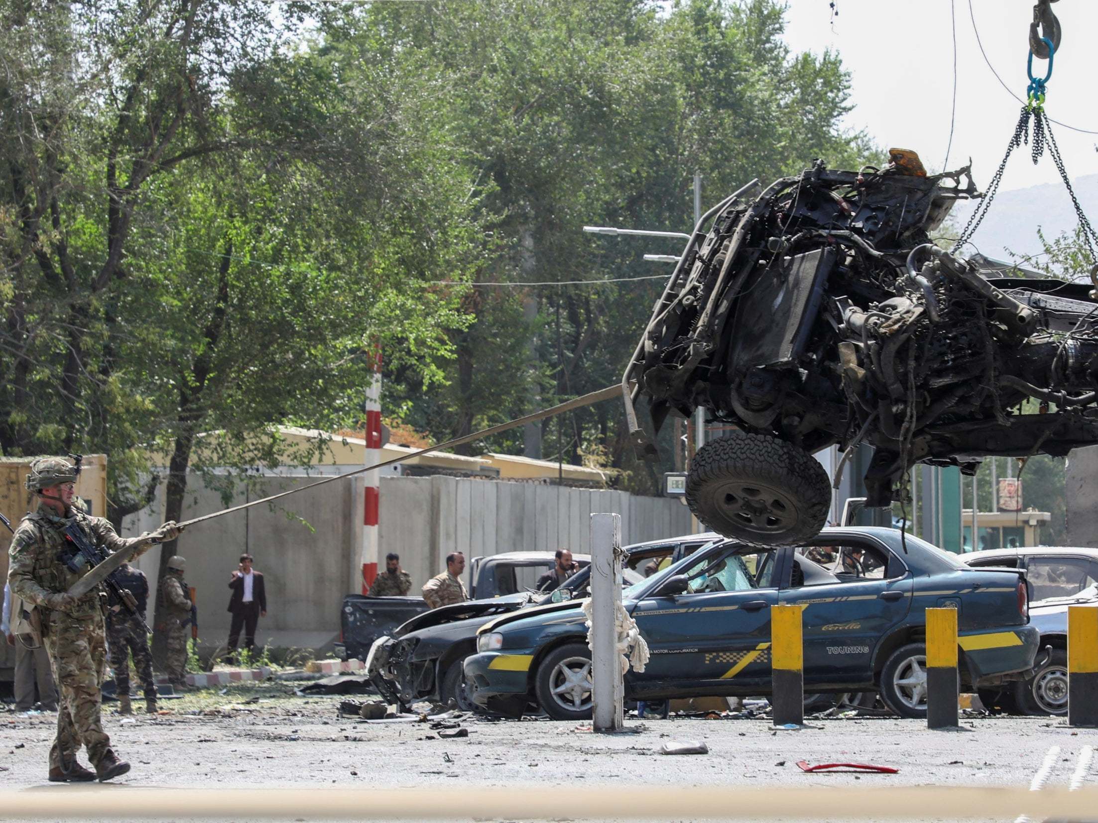 A foreign soldier with NATO-led Resolute Support Mission inspects at the site of a suicide attack in Kabul, Afghanistan 5 September 2019