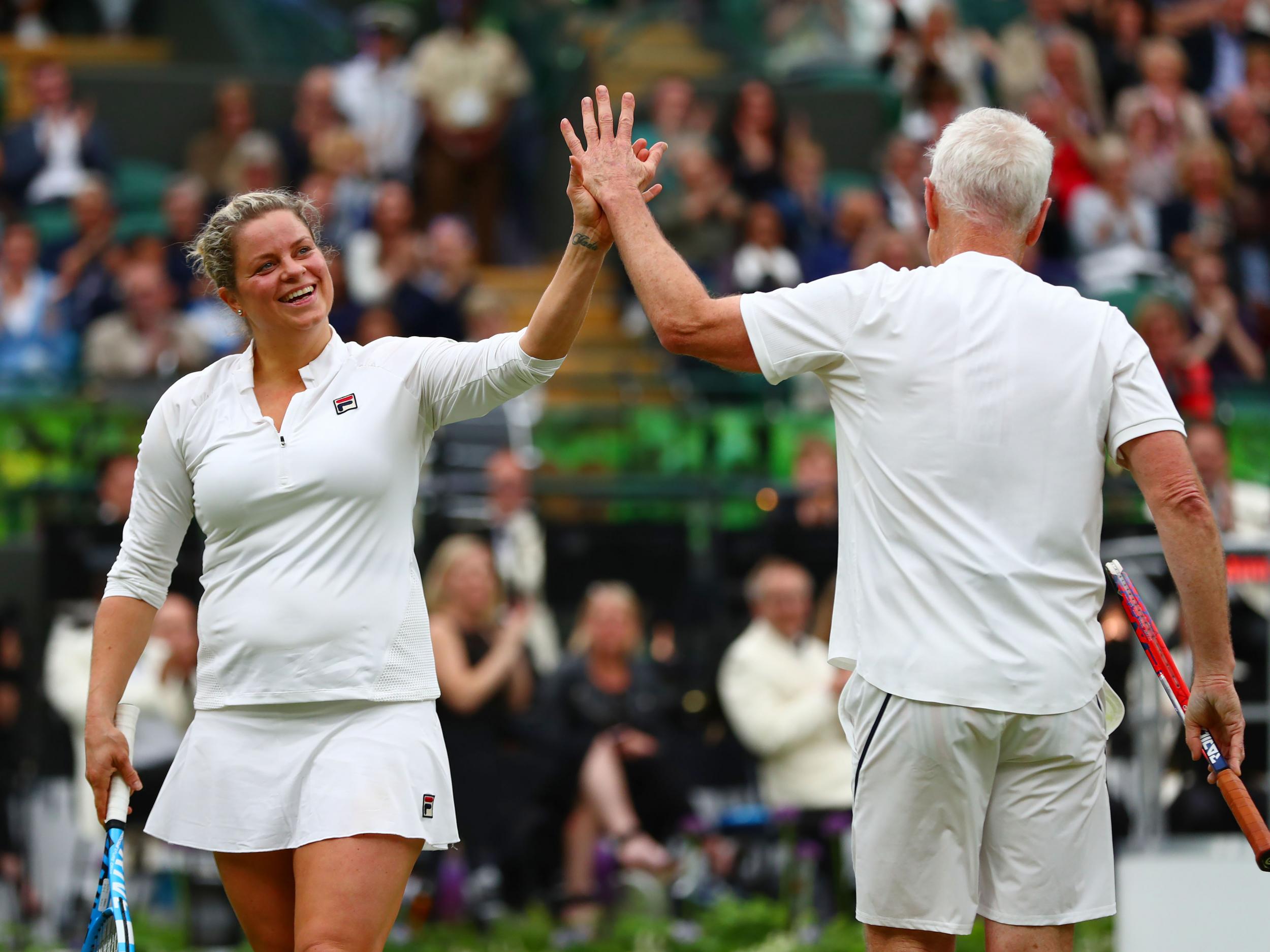 Kim Clijsters helped open the new roof on the No.1 Court at Wimbledon alongside John McEnroe