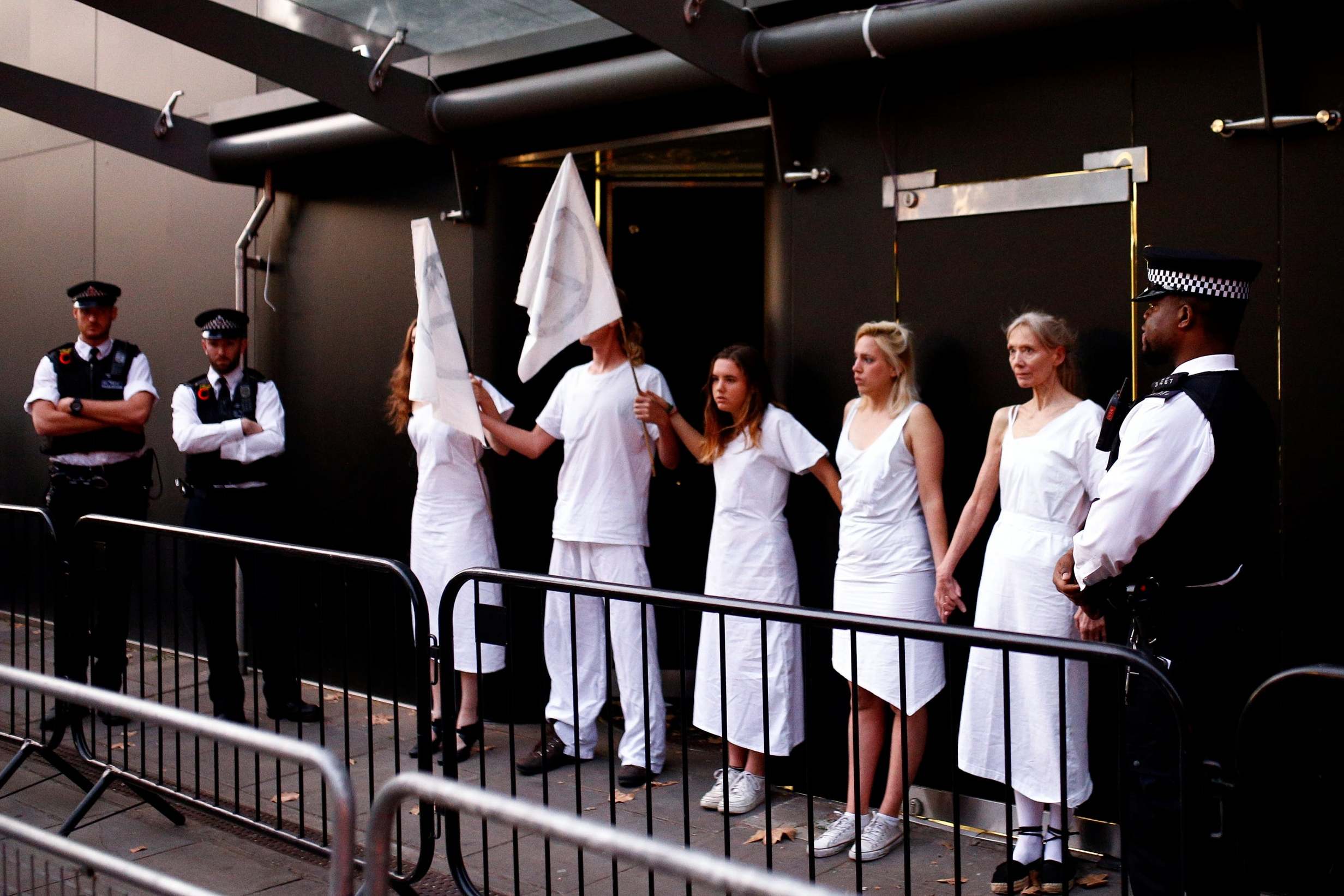 Demonstrators also glued themselves to the entrance of the event (Reuters)