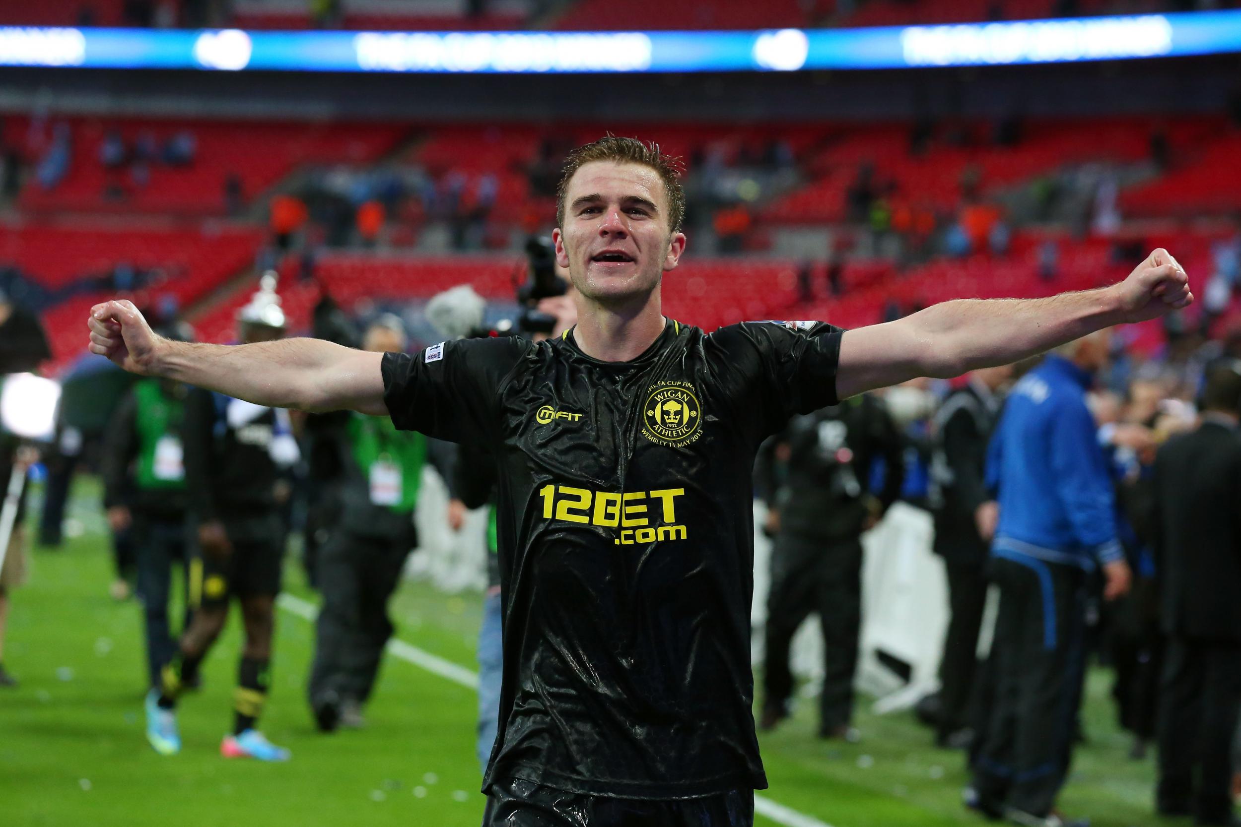 McManaman celebrates on the Wembley pitch after winning the FA Cup