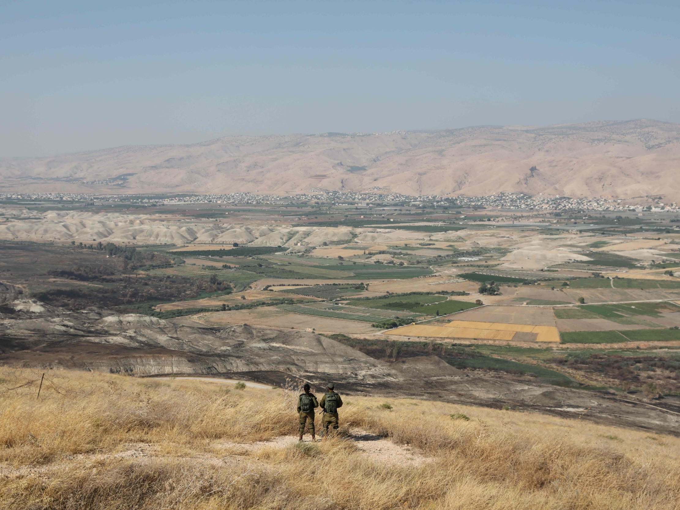 Israeli soldiers stand guard in an outpost overlooking the valley (AFP/Getty)