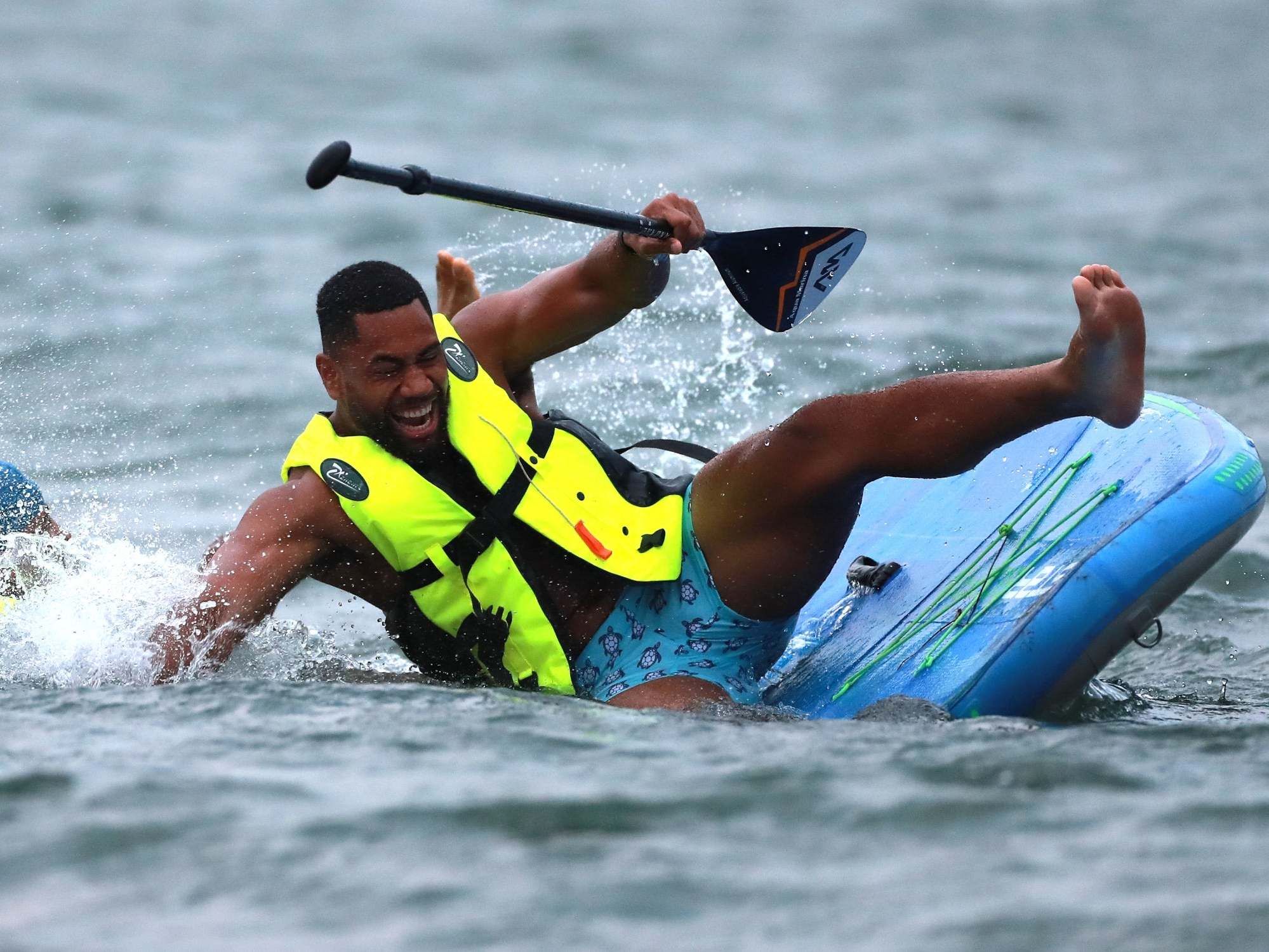 Joe Cokanasiga gets to grips with paddleboarding during England's training camp in Miyazaki