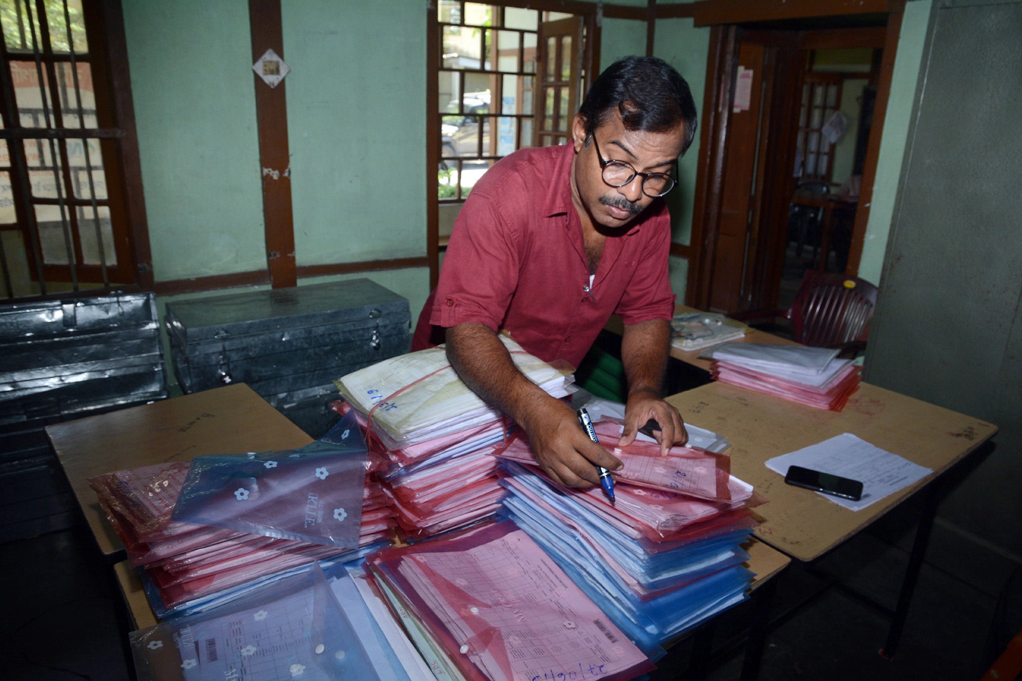 An office worker checks documents ahead of the release of the final draft of the NRC