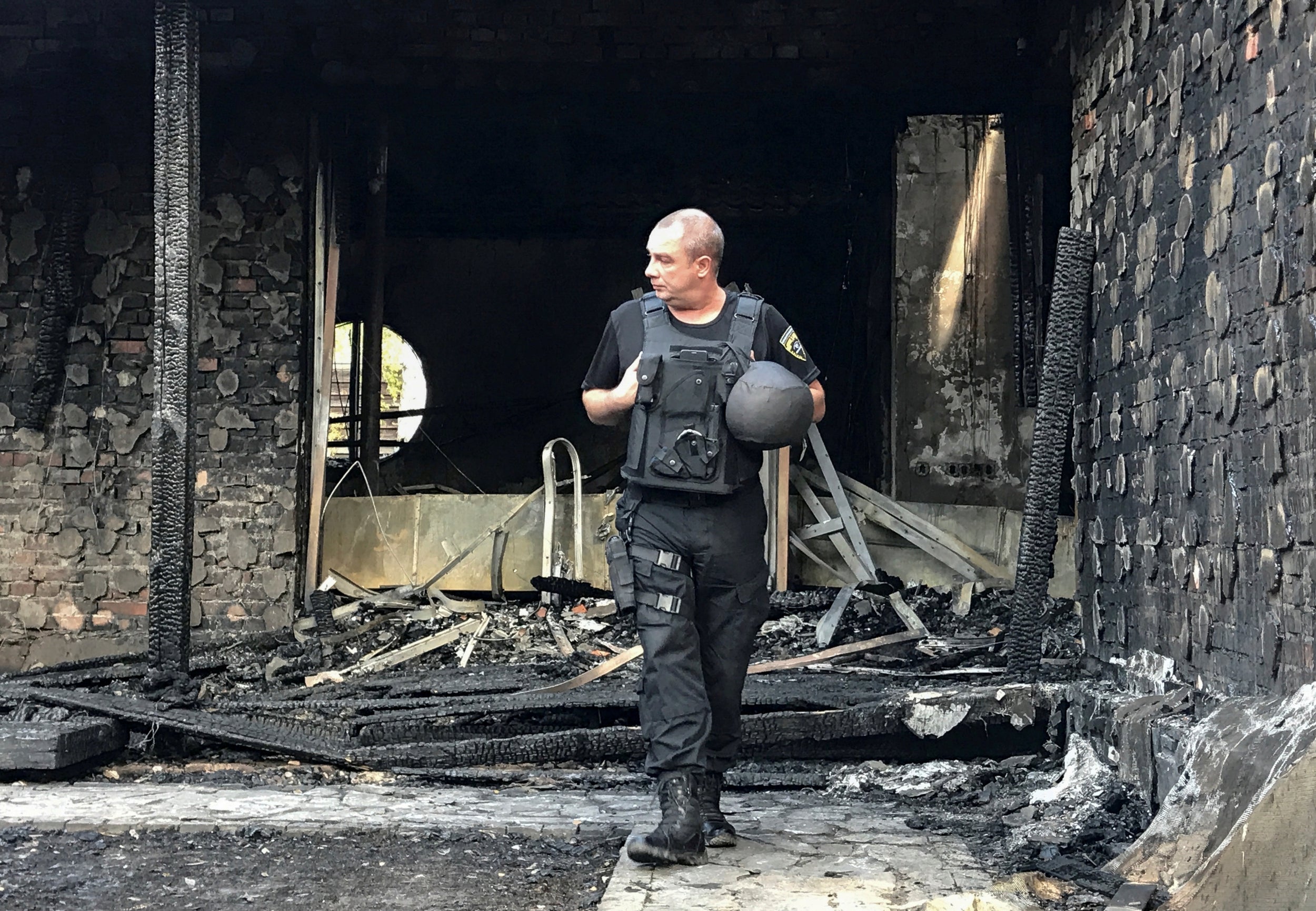 Police inspect the remains of Ms Gontareva's Kiev home on Tuesday