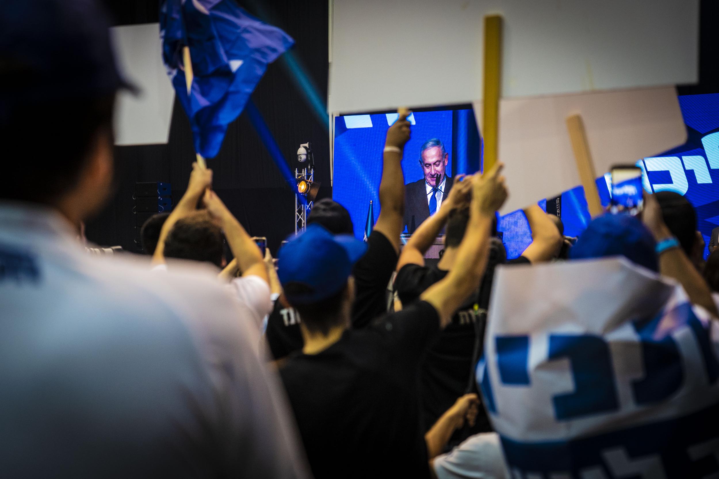 Supporters chant “no to unity” government at Netanyahu who did not concede defeat or declare victory in a 3am speech in Tel Aviv