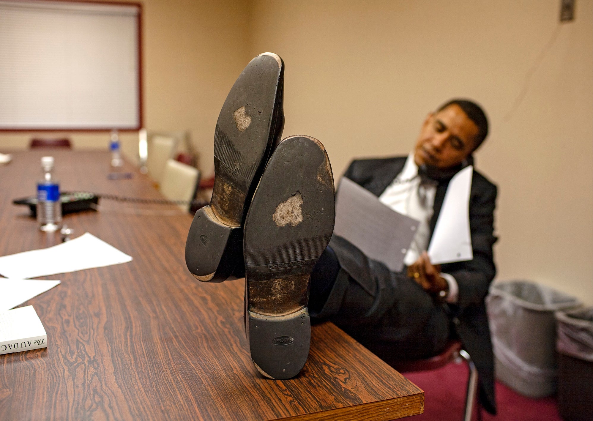 Obama doing press interviews by phone between events. ‘When he saw me photographing his shoes, he said he had already had them resoled once since he entered the race. They were his lucky shoes...’