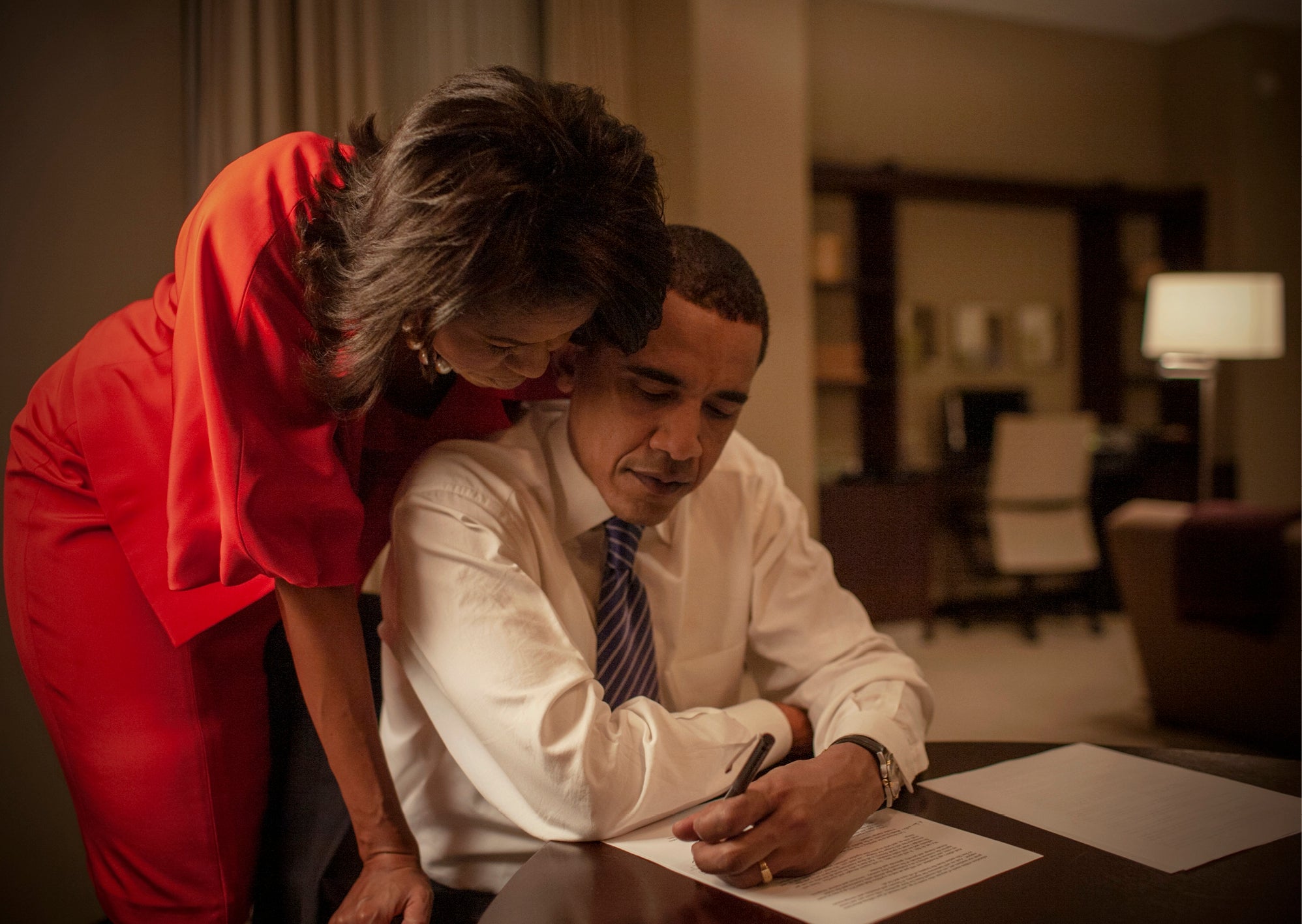 Michelle Obama looks over Obama's remarks to supporters before the Super Tuesday election night rally. In a surprise twist, Obama surpassed Hillary Clinton in delegate numbers
