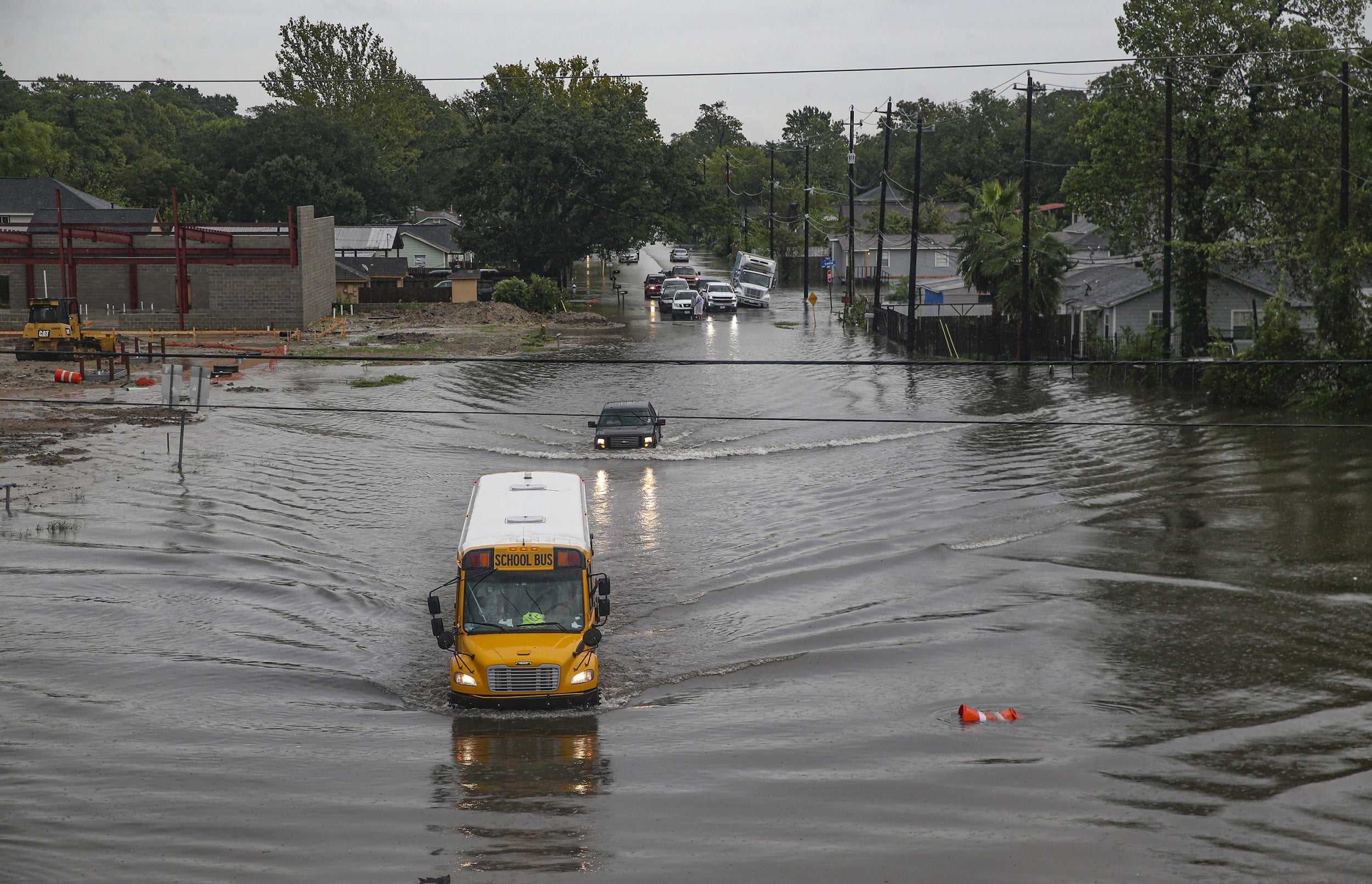 A school bus drives through floodwater in Houston, Texas