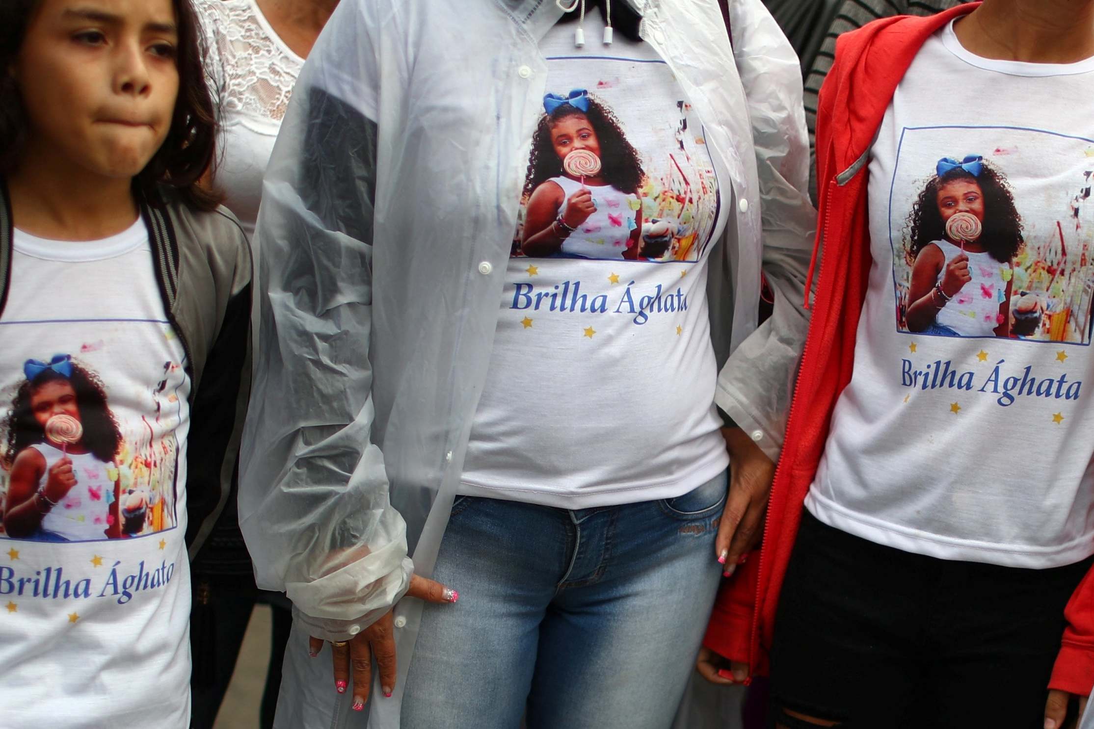 Relatives and friends wear commemorative shirts at the funeral of 8-year-old Agatha Felix