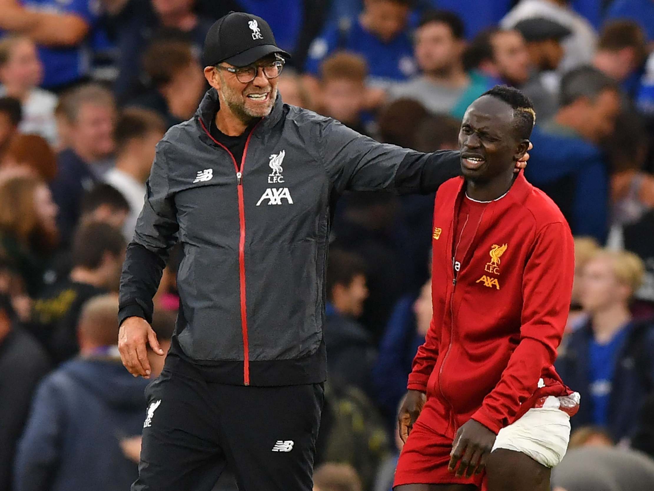 Liverpool manager Jurgen Klopp checks on Sadio Mane