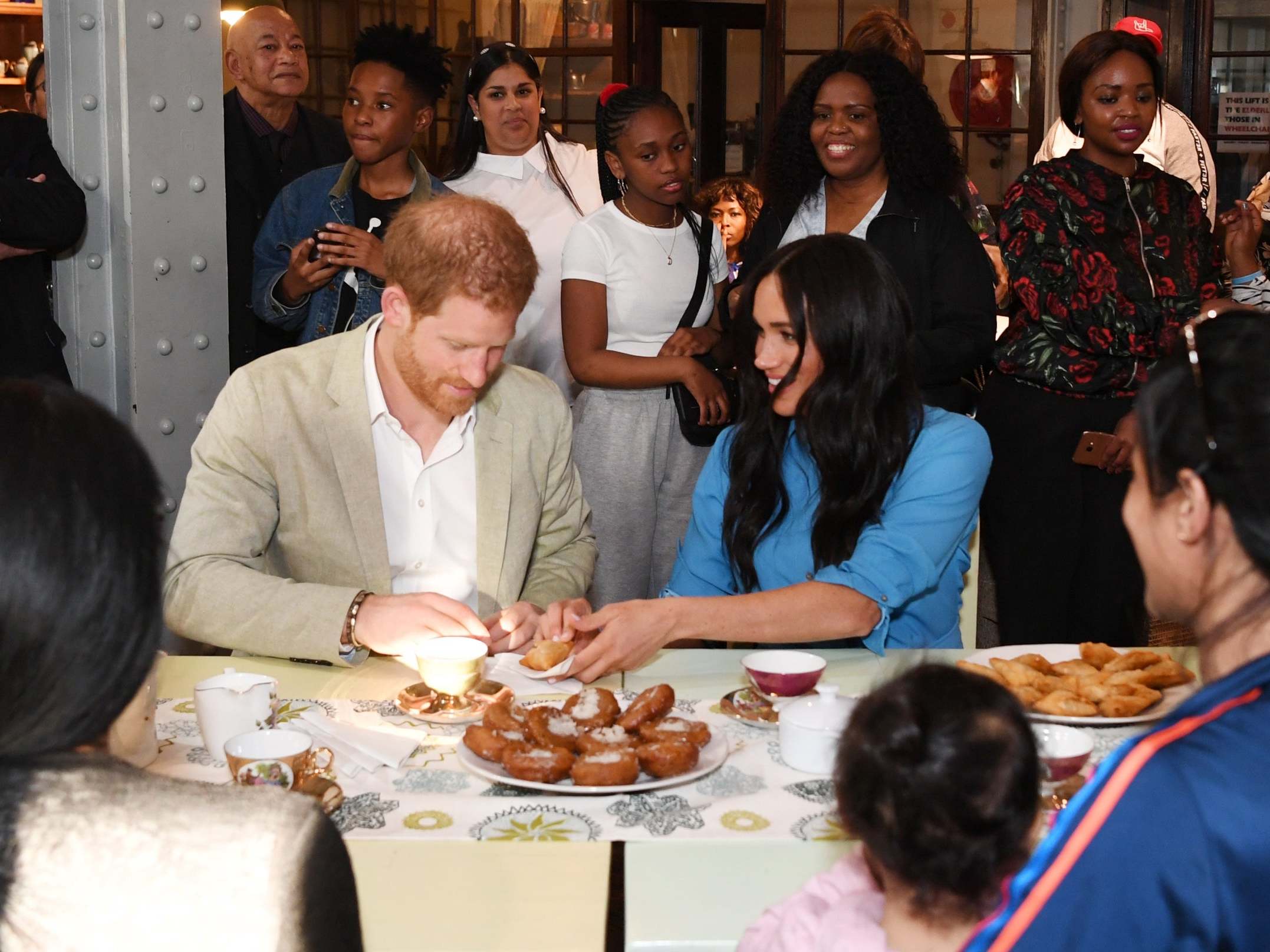 The Duke and Duchess of Sussex try local food at the Homecoming Centre