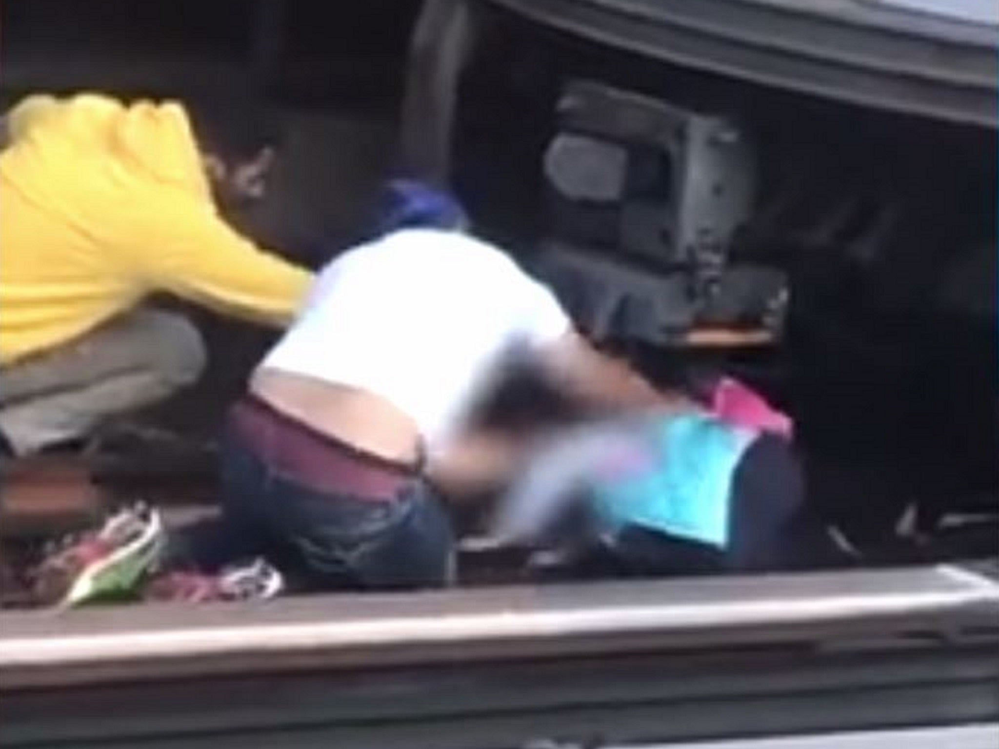 Still image from video of five-year-old girl being pulled to safety at Kingsbridge Station, the Bronx, New York, after her father 'jumped' in front of a train while holding her, 23 September, 2019.