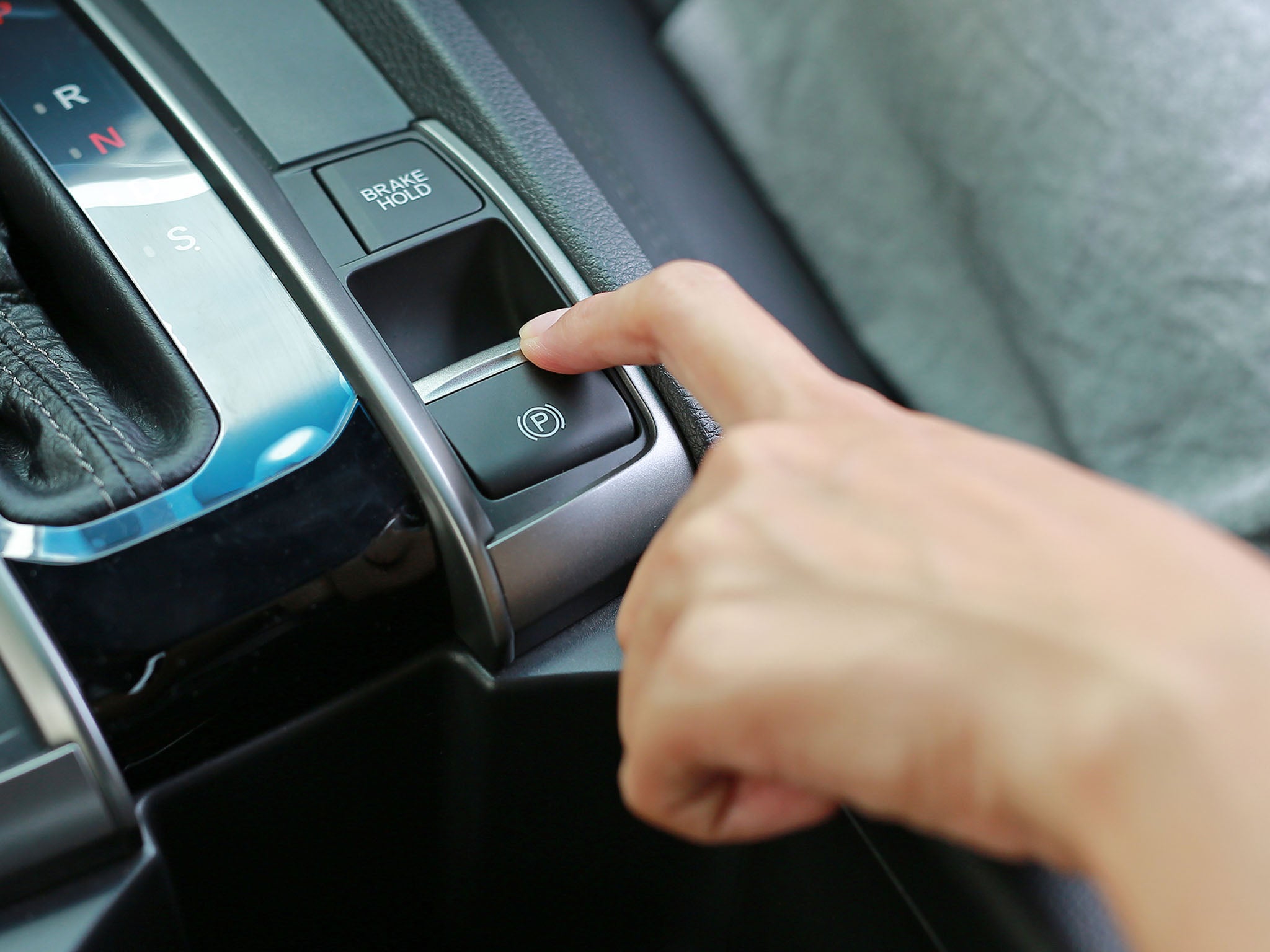 An electronic parking brake is operated via a switch that replaces the traditional mechanical lever