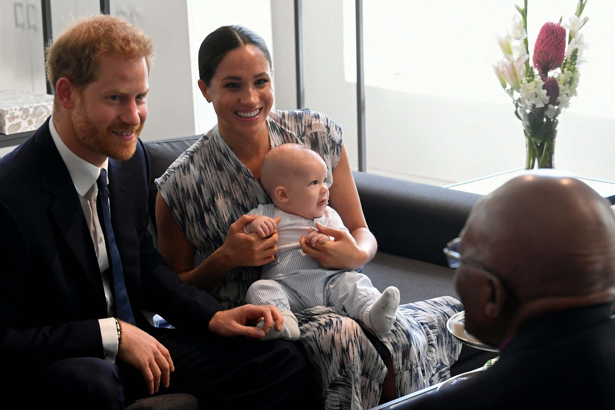 Prince Harry and Meghan speak with Archbishop Desmond Tutu as their son, Archie, looks on