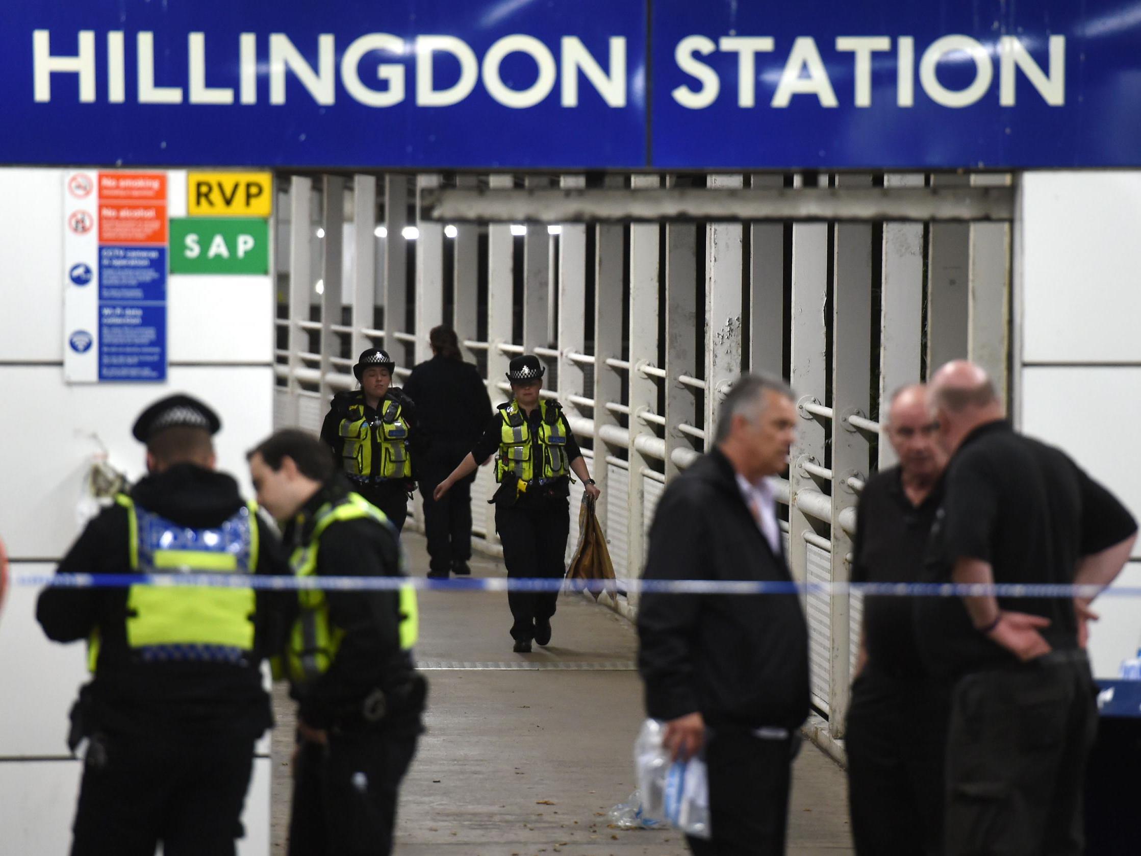 Police outside Hillingdon underground station in London, where a murder investigation has been launched after a man was stabbed to death.