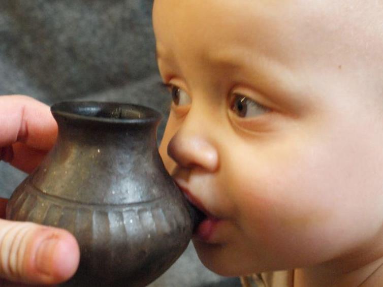 The vessel (reconstruction) is small enough to fit in a baby’s hand and has a little spout through which the baby would have suckled