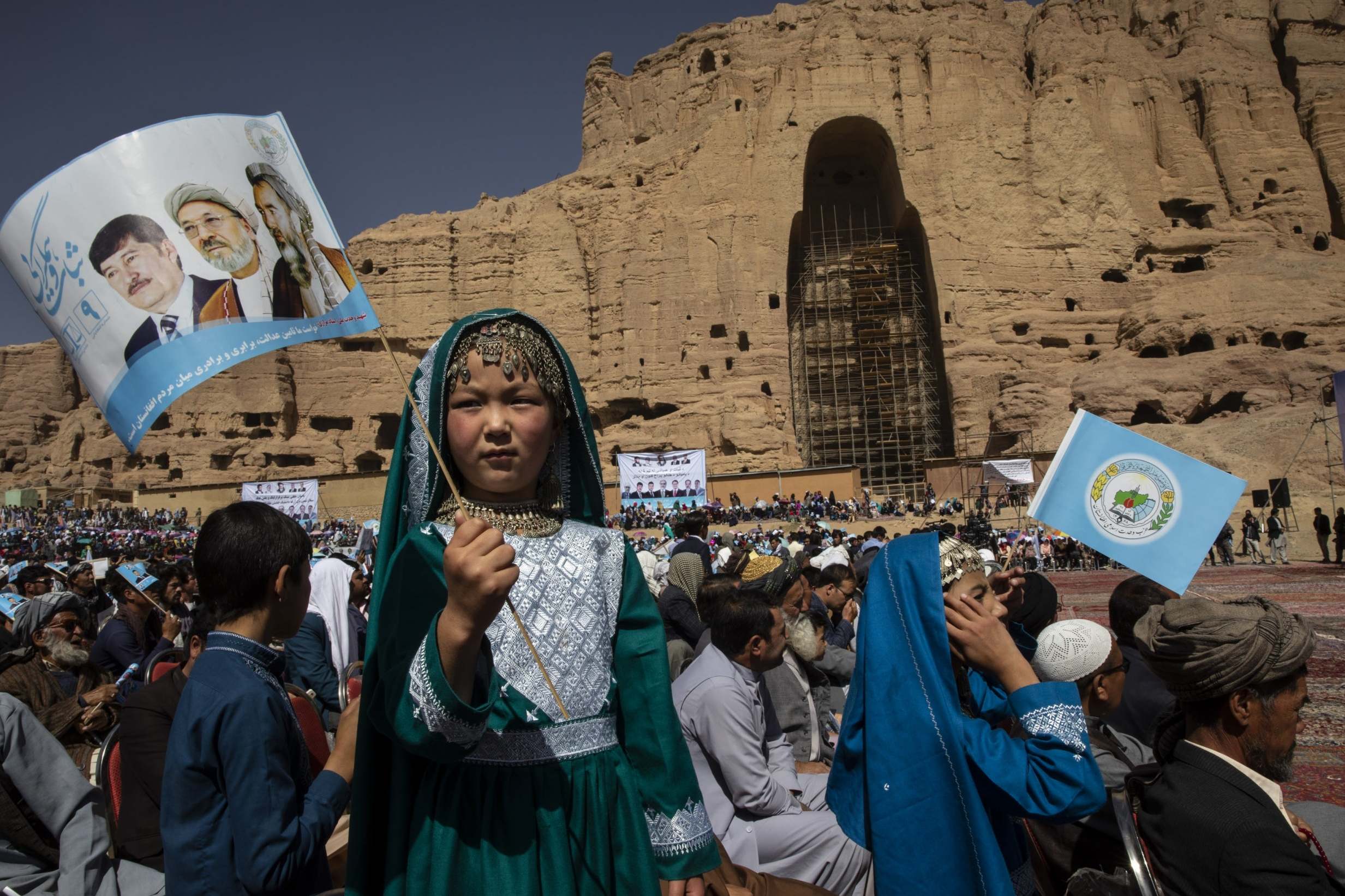 Afghans listen to speeches during the final campaign rally for Abdullah Abdullah