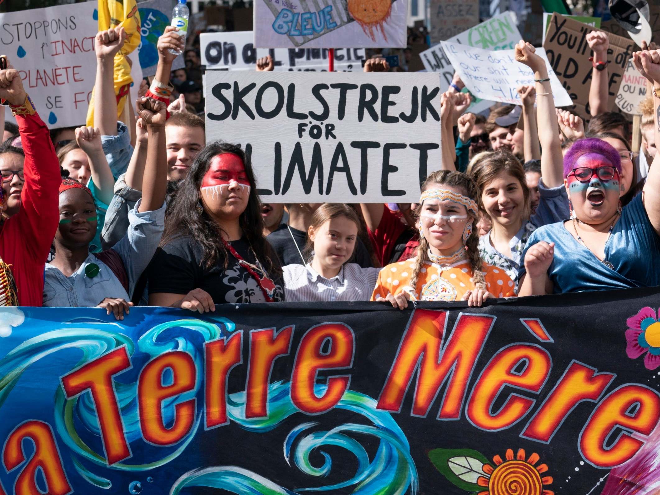 Swedish activist and student Greta Thunberg, centre, takes part in the Climate Strike in Montreal on Friday 27 September