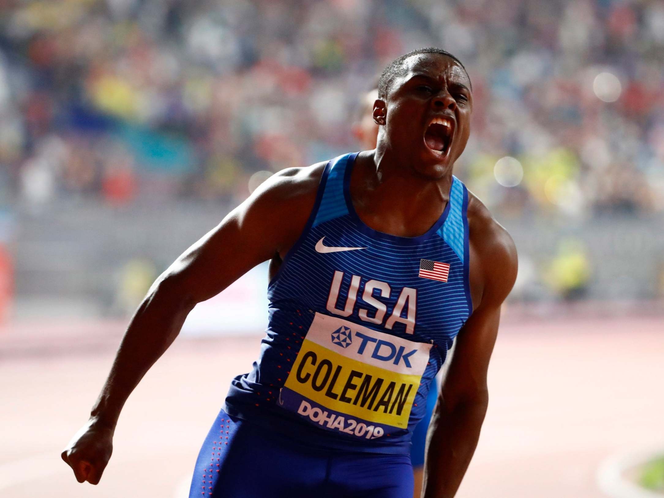 Christian Coleman celebrates crossing the line